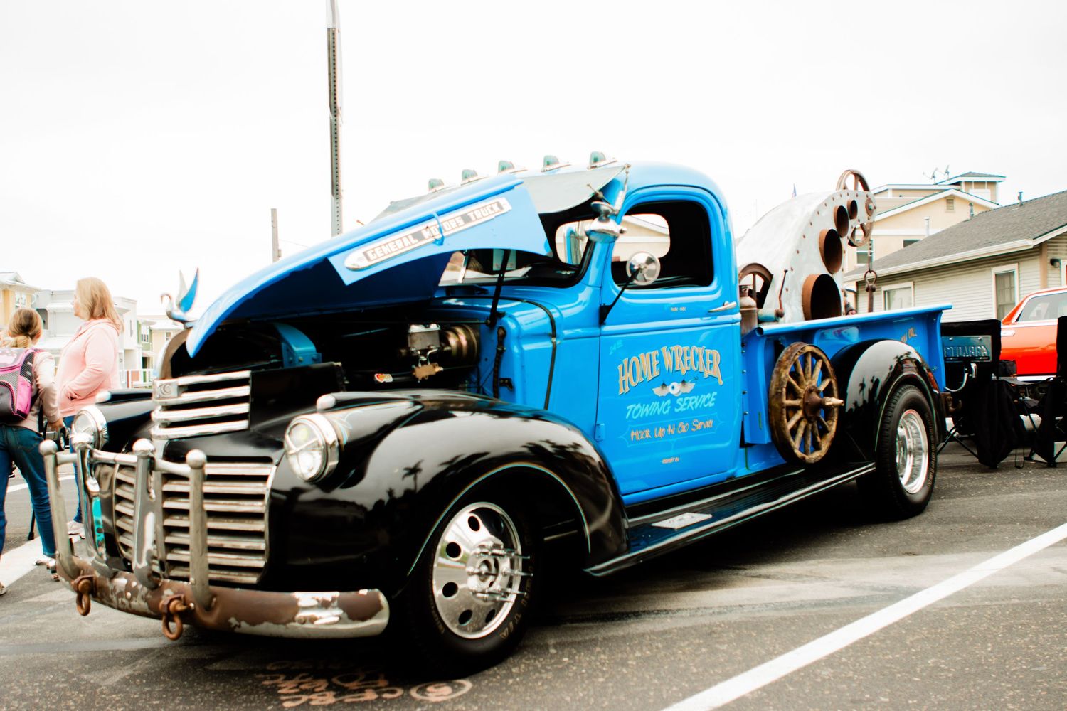 Vintage blue Dodge tow truck restored with custom paint and chrome details parked at a car show.