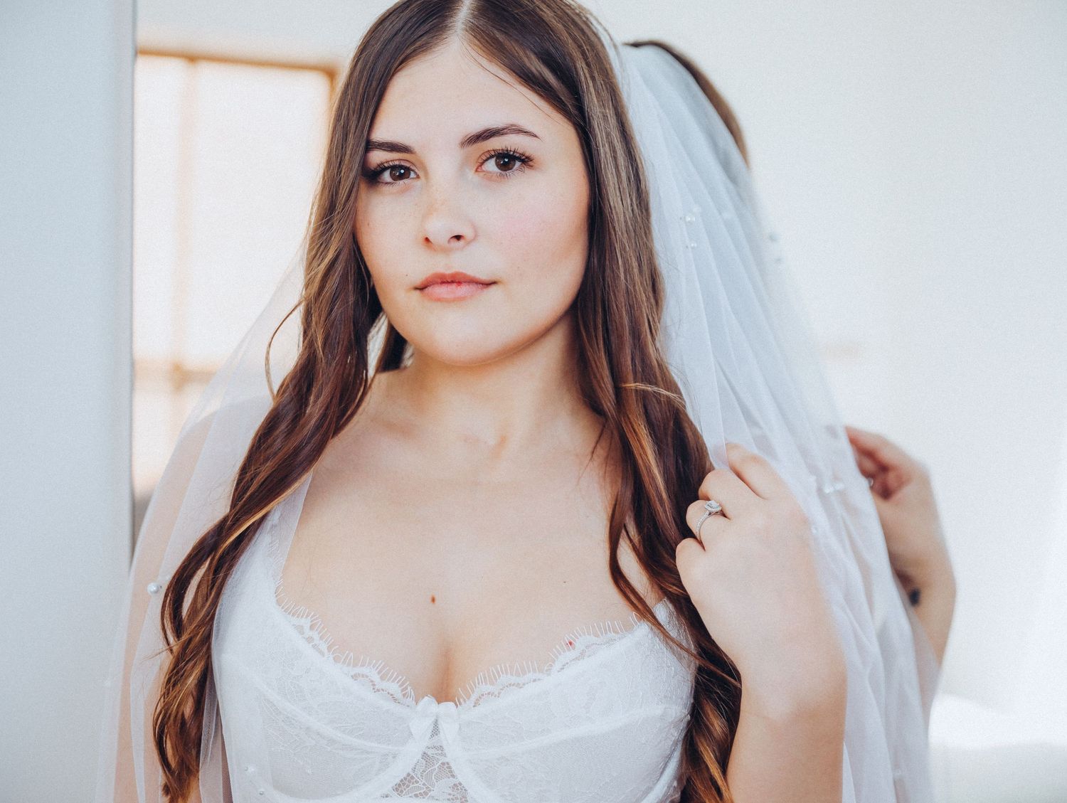 Bride for bridal boudoir photoshoot wearing white lingerie and veil for Boudoir by Bri in Saint Louis Missouri for wedding groom gift