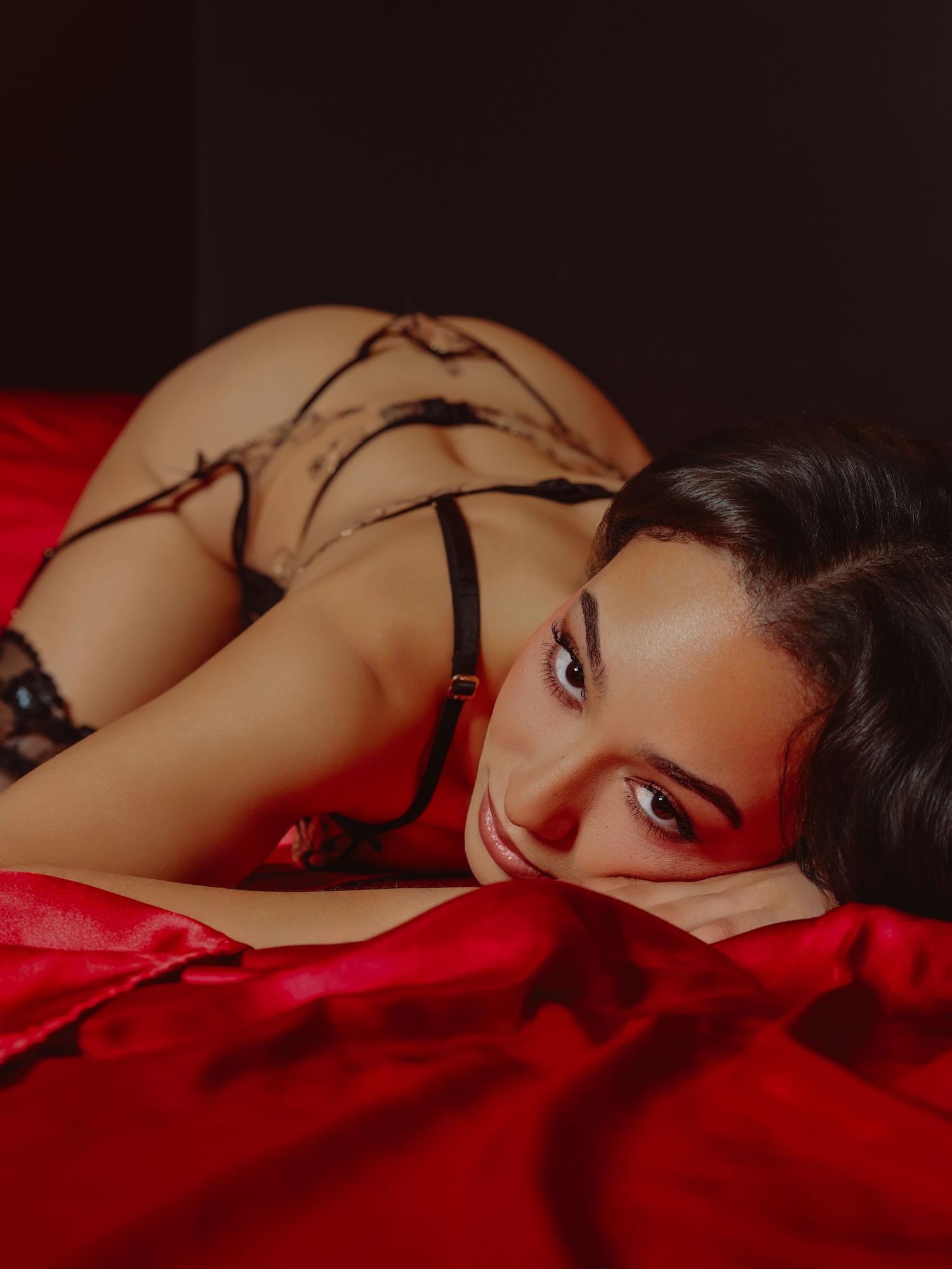 Boudoir by Bri photoshoot of beautiful young woman posing suggestively and looking up at camera for studio session in St. Louis