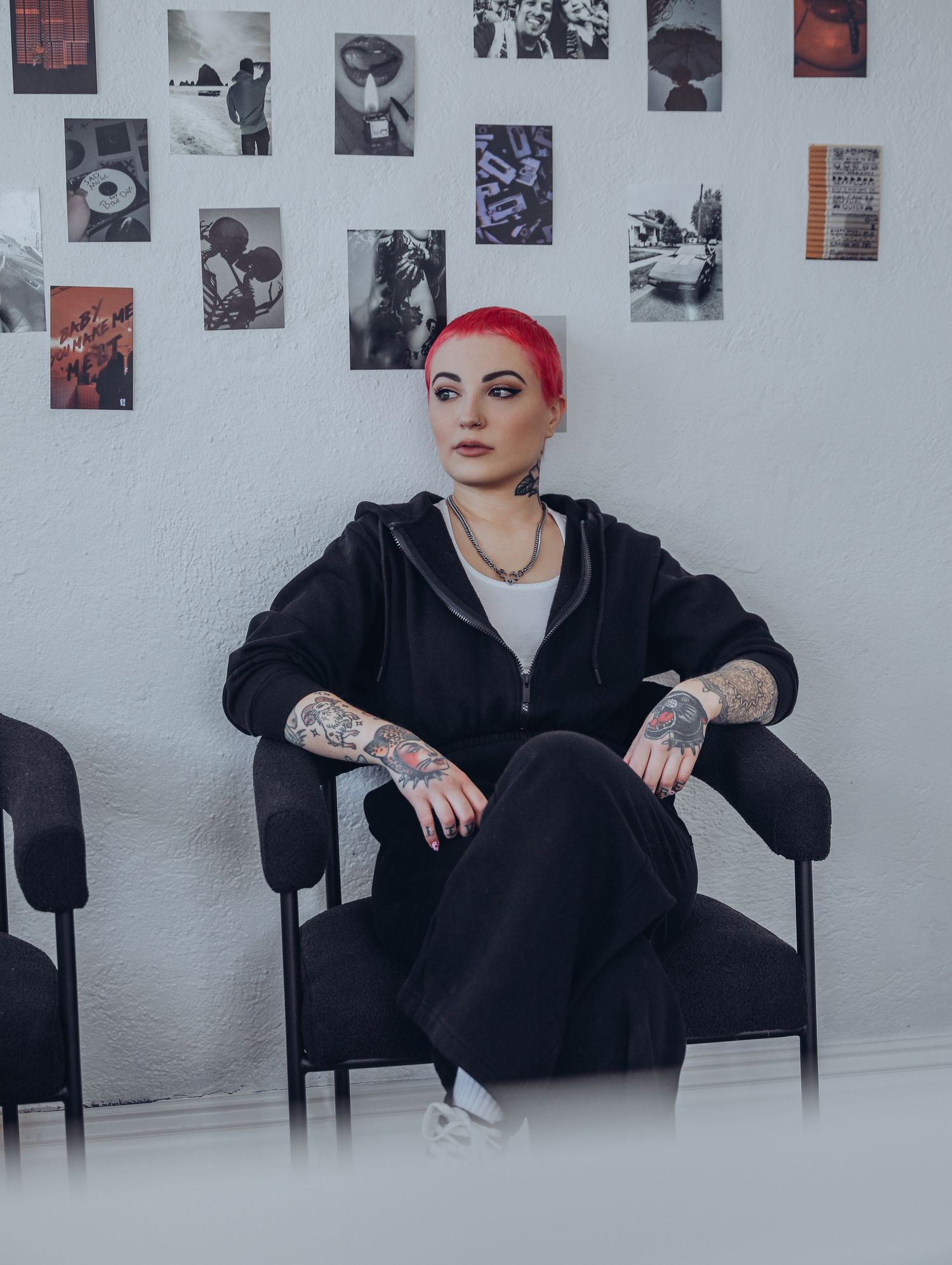 Boudoir by Bri photoshoot of small business branding and headshots for tattoo artist with pink hair in black jumpsuit in St. Louis, MO