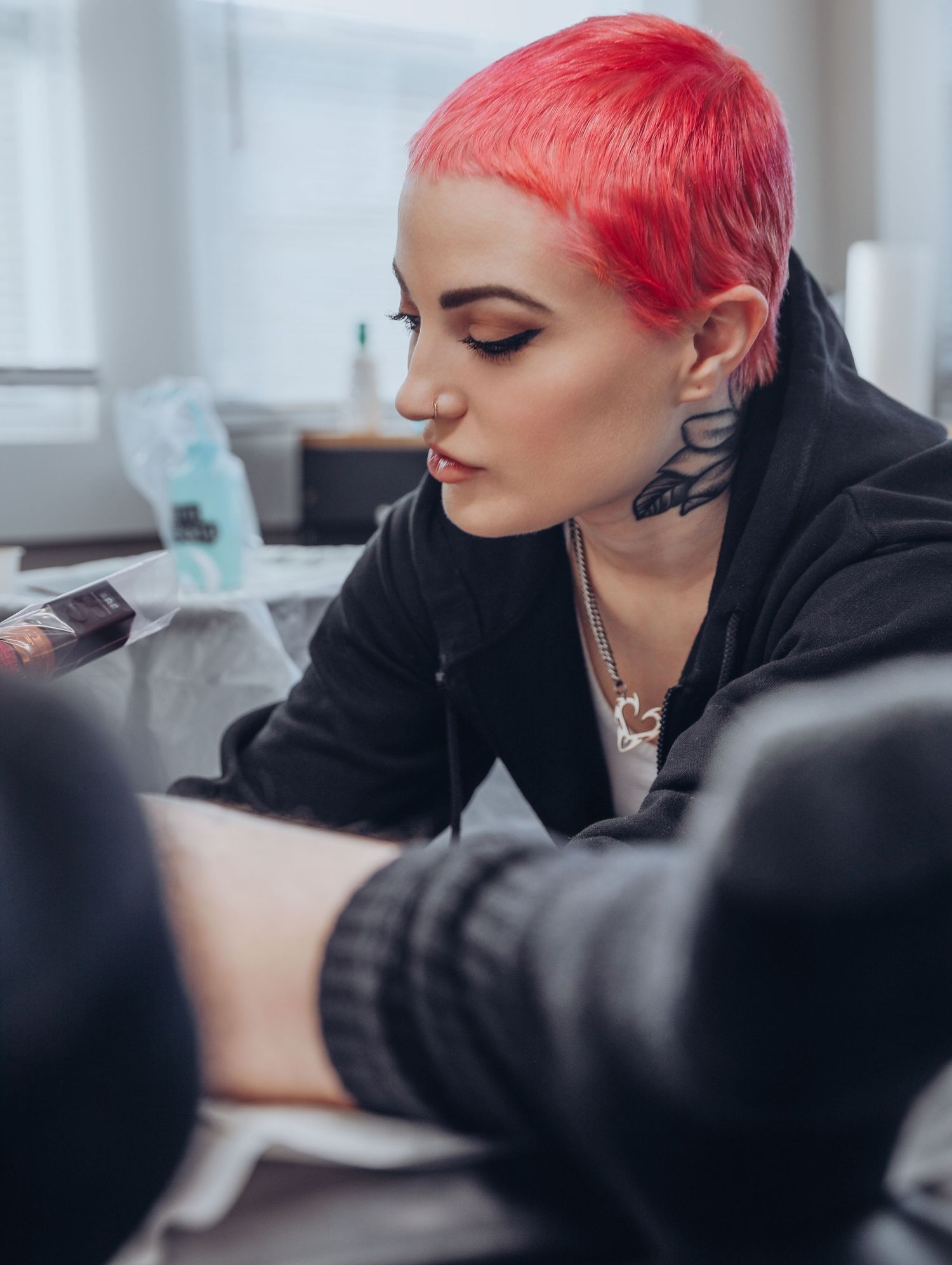 Boudoir by Bri photoshoot of small business branding and headshots for tattoo artist with pink hair in black jumpsuit in St. Louis, MO