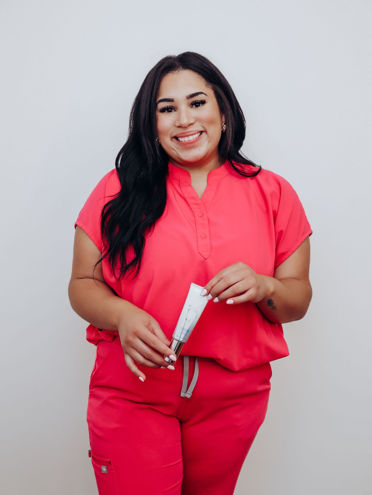 Boudoir by Bri photoshoot of small business branding and headshots for esthetician in St. Louis, in studio and wearing scrubs, skincare