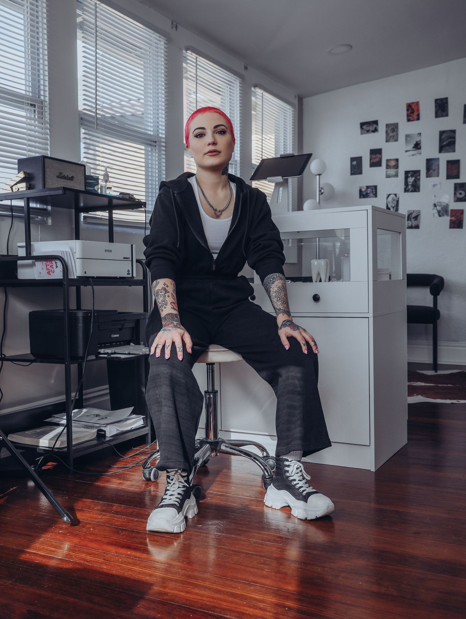 Boudoir by Bri photoshoot of small business branding and headshots for tattoo artist with pink hair in black jumpsuit in St. Louis, MO
