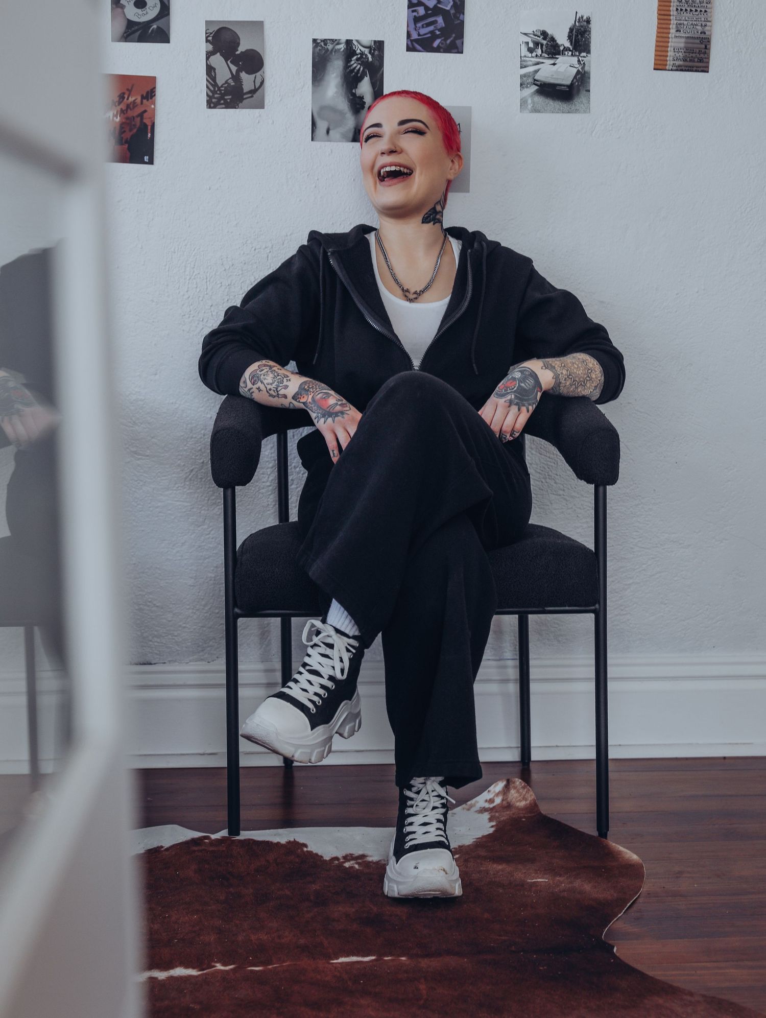 Boudoir by Bri photoshoot of small business branding and headshots for tattoo artist with pink hair in black jumpsuit in St. Louis, MO