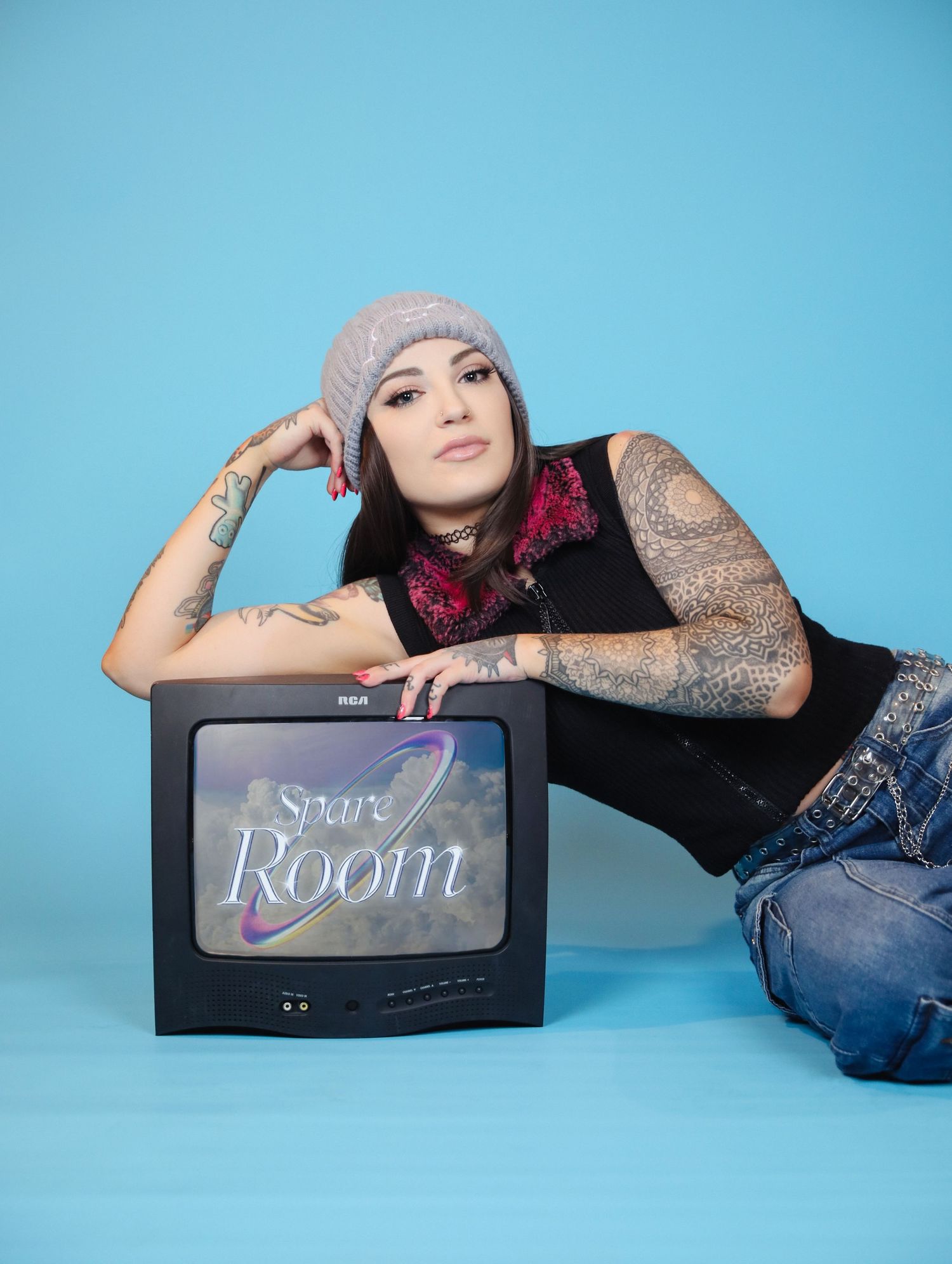 Boudoir by Bri creative photoshoot of small business branding and headshots for tattoo artist with vintage tv logo in St. Louis, MO