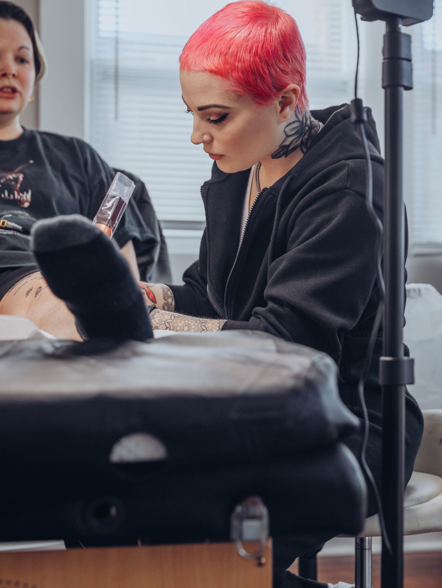 Boudoir by Bri photoshoot of small business branding and headshots for tattoo artist with pink hair in black jumpsuit in St. Louis, MO