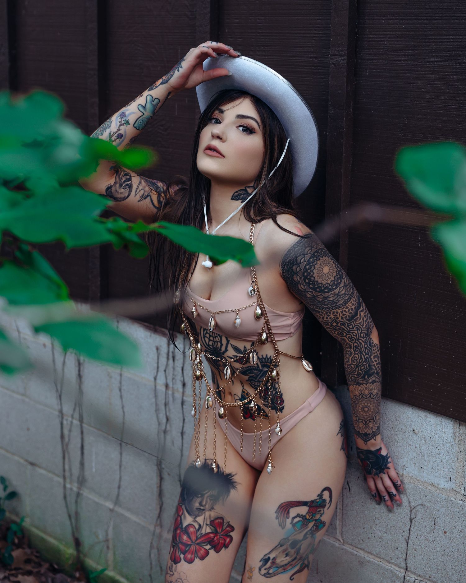 Beautiful tattooed woman in bikini and cowboy hat outdoor boudoir shoot with Boudoir by Bri in Saint Louis