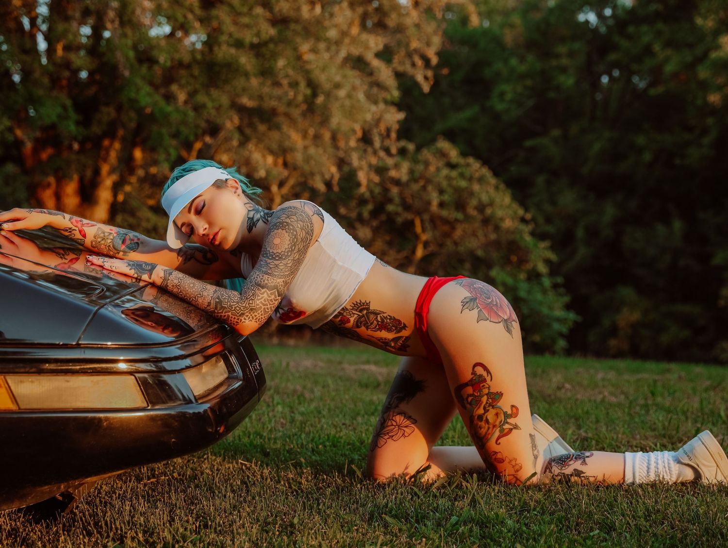 Woman posing by convertible classic vintage car for outdoor boudoir session in Saint Louis with Boudoir by Bri
