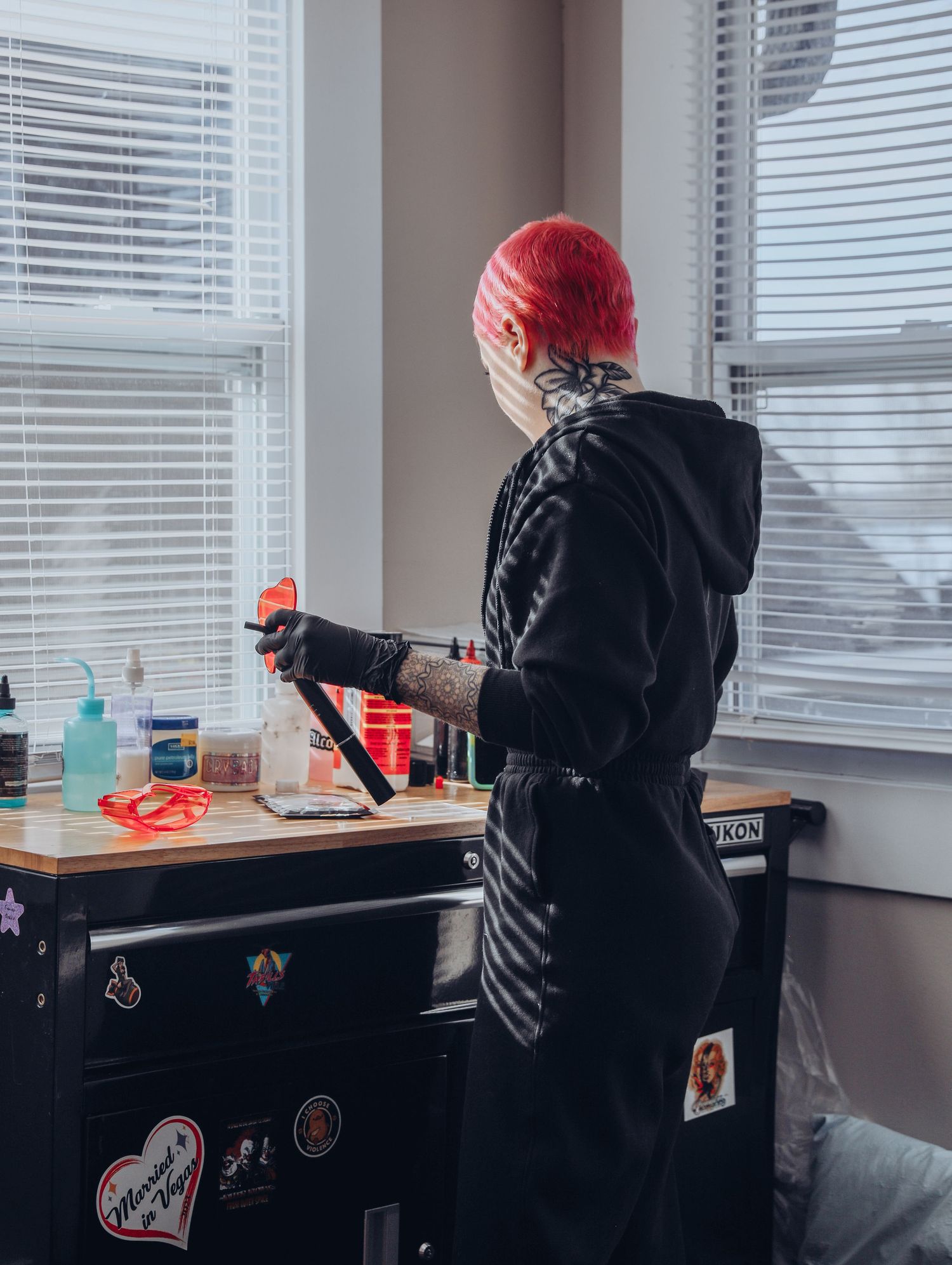 Boudoir by Bri photoshoot of small business branding and headshots for tattoo artist with pink hair in black jumpsuit in St. Louis, MO