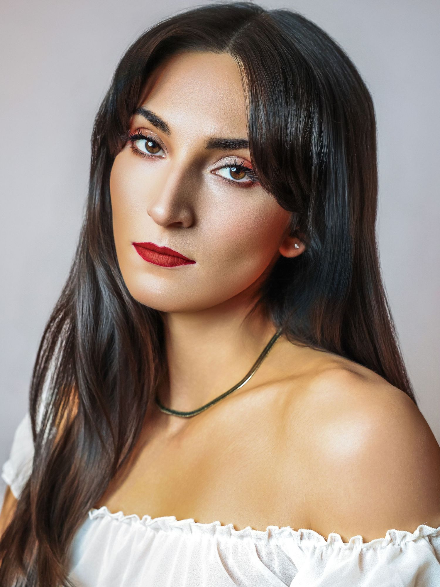 Headshot of woman with long black hair and curtain bangs with spray tan for photoshoot with Boudoir by Bri in Saint Louis Missouri