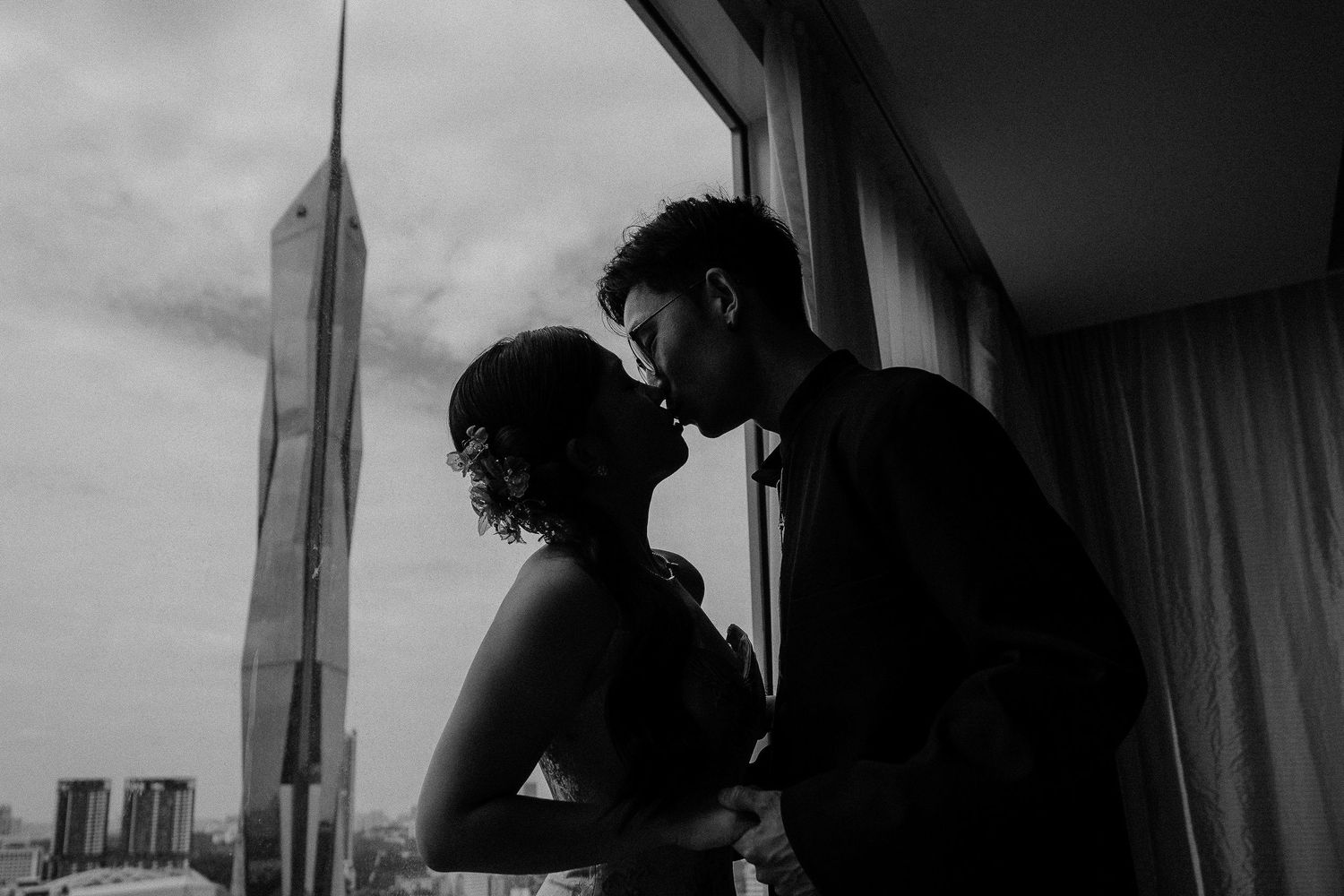 A couple kissing in front of Menara 118, Kuala Lumpur, Malaysia