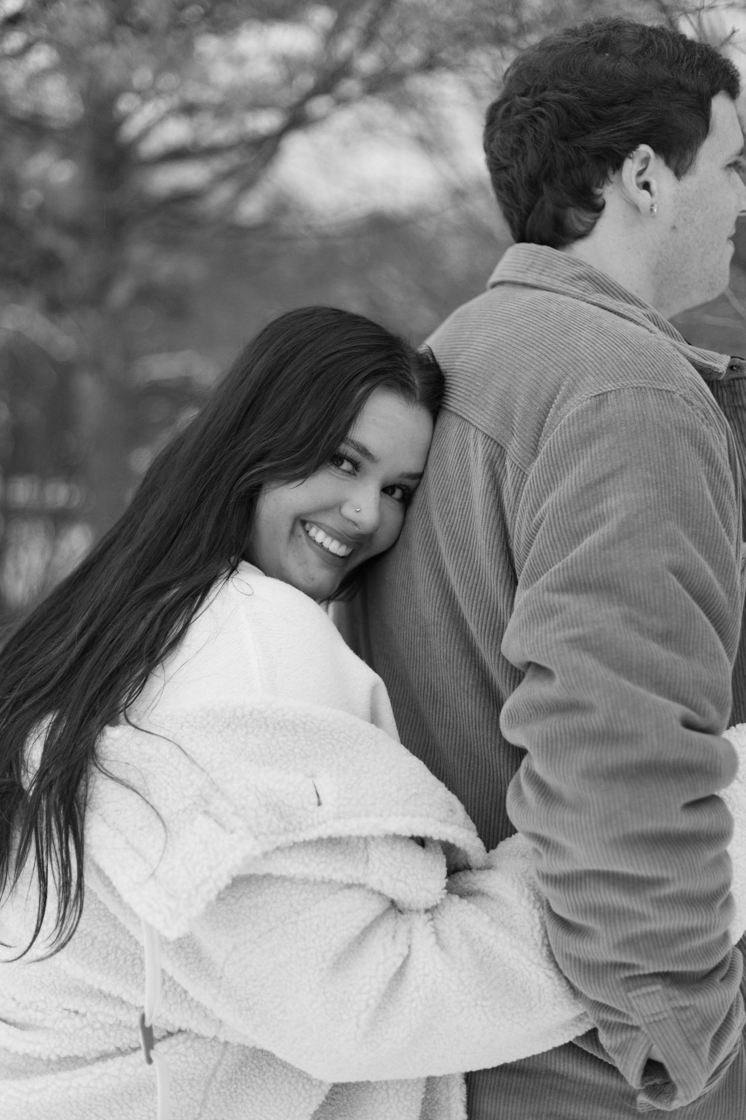 Black and white photo of couple in intimate winter embrace.