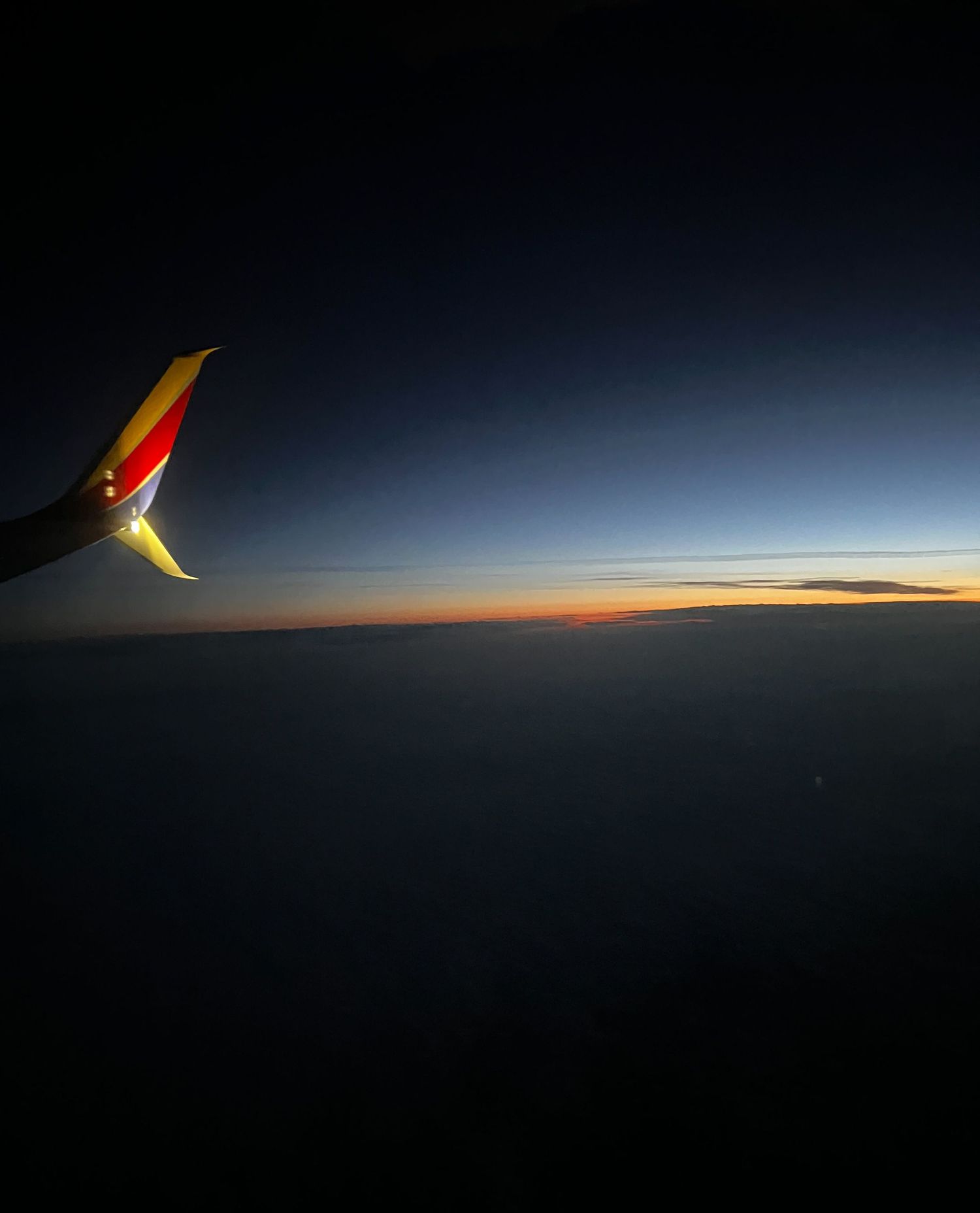 Airplane in the wee hours of the morning up in the clouds