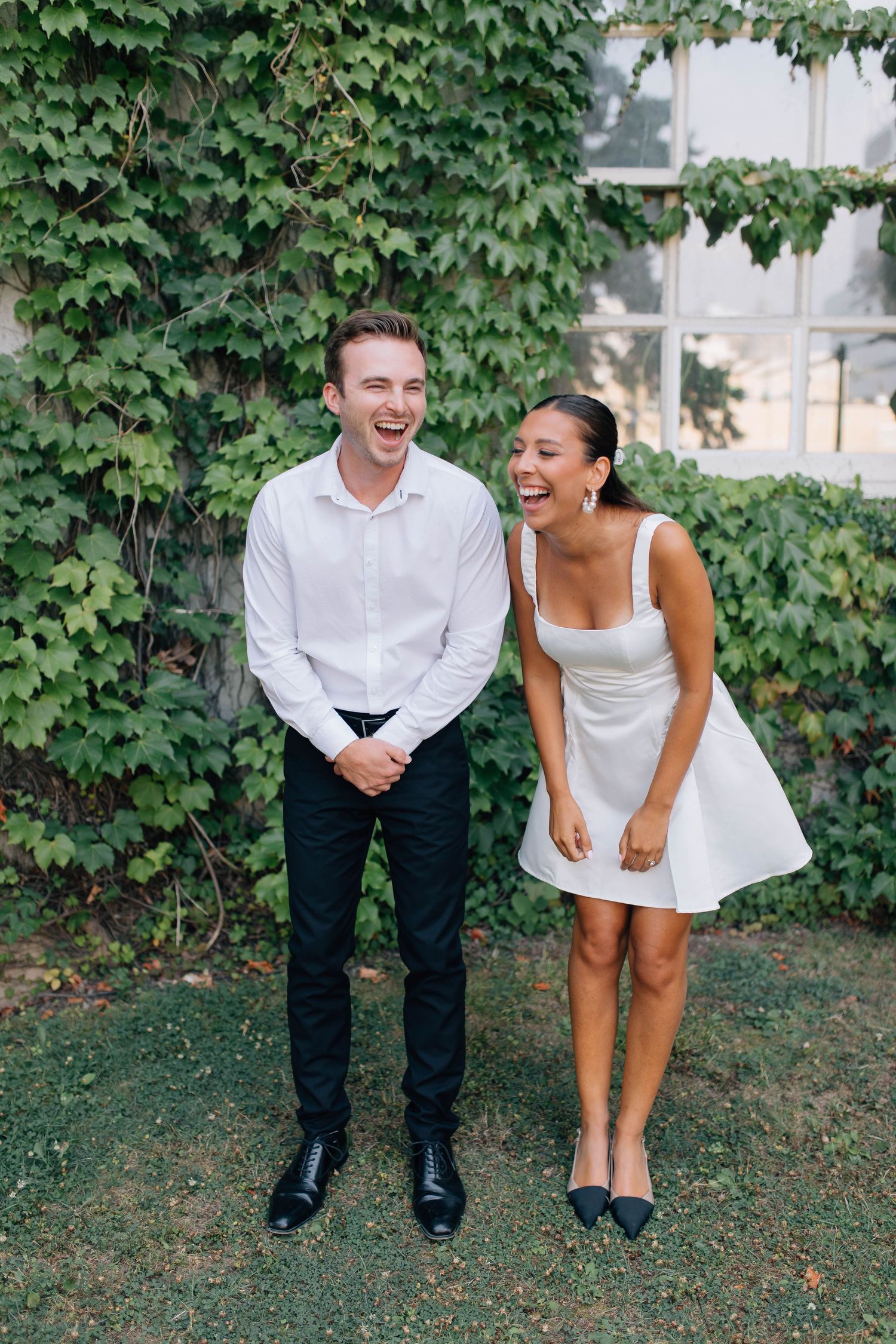 Couple laughing in front of the Old Courthouse in London Ontario