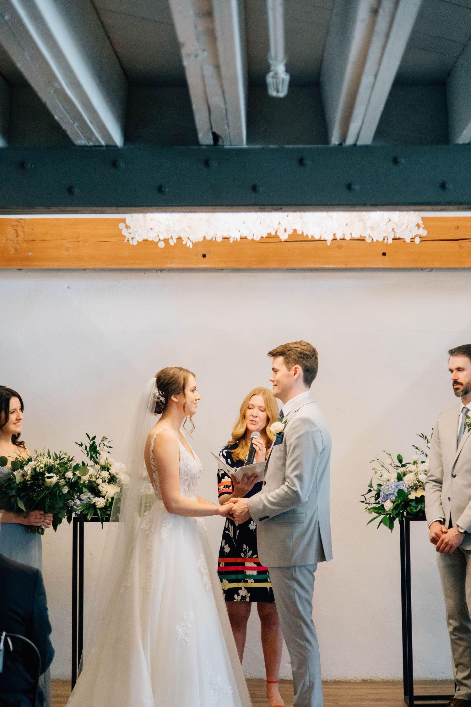 Bride and groom holding hands during ceremony at the Timber Barn in St. Jacob's Ontario
