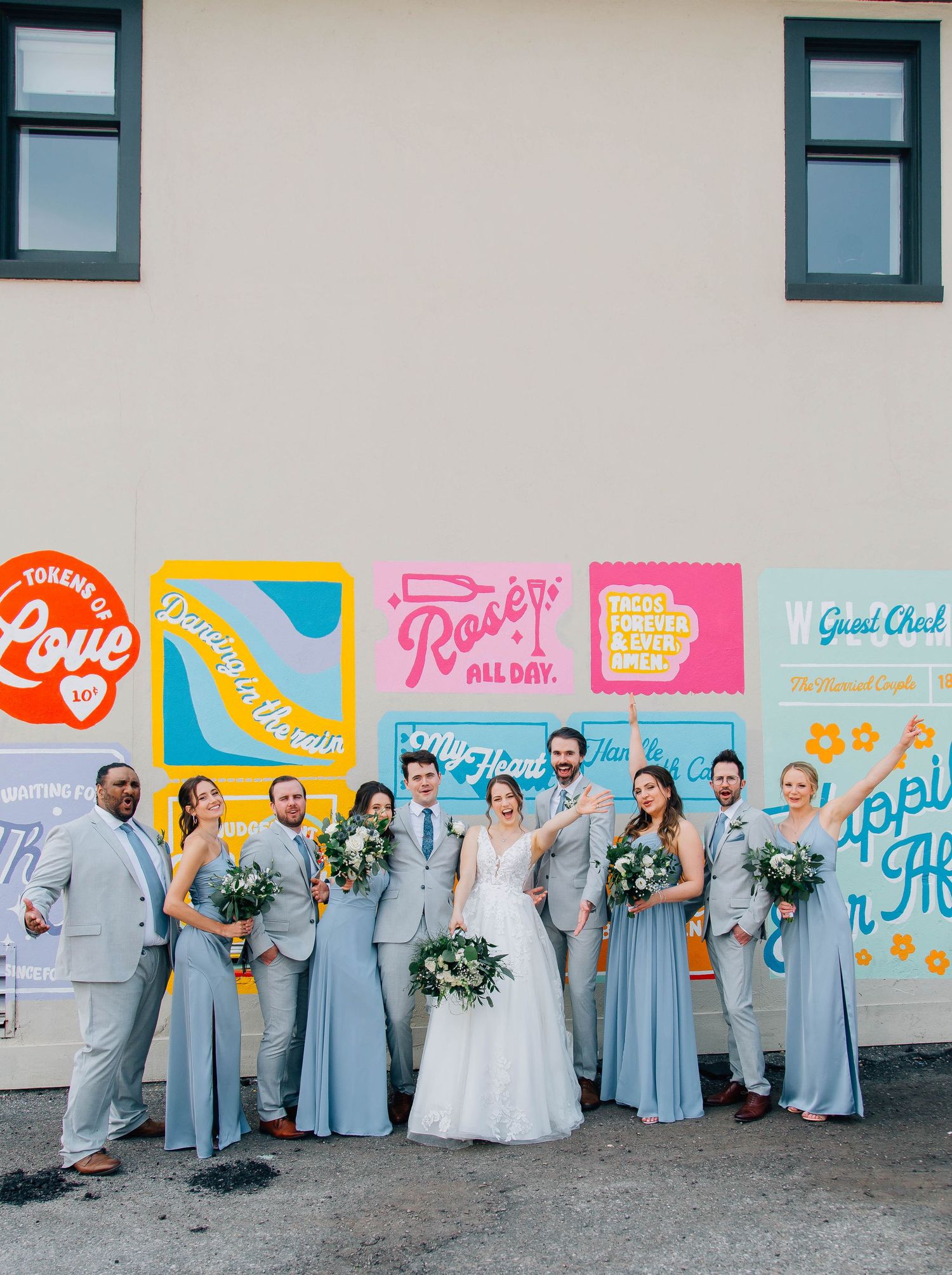 Wedding party posing in front of mural located in St. Jacob's Ontario