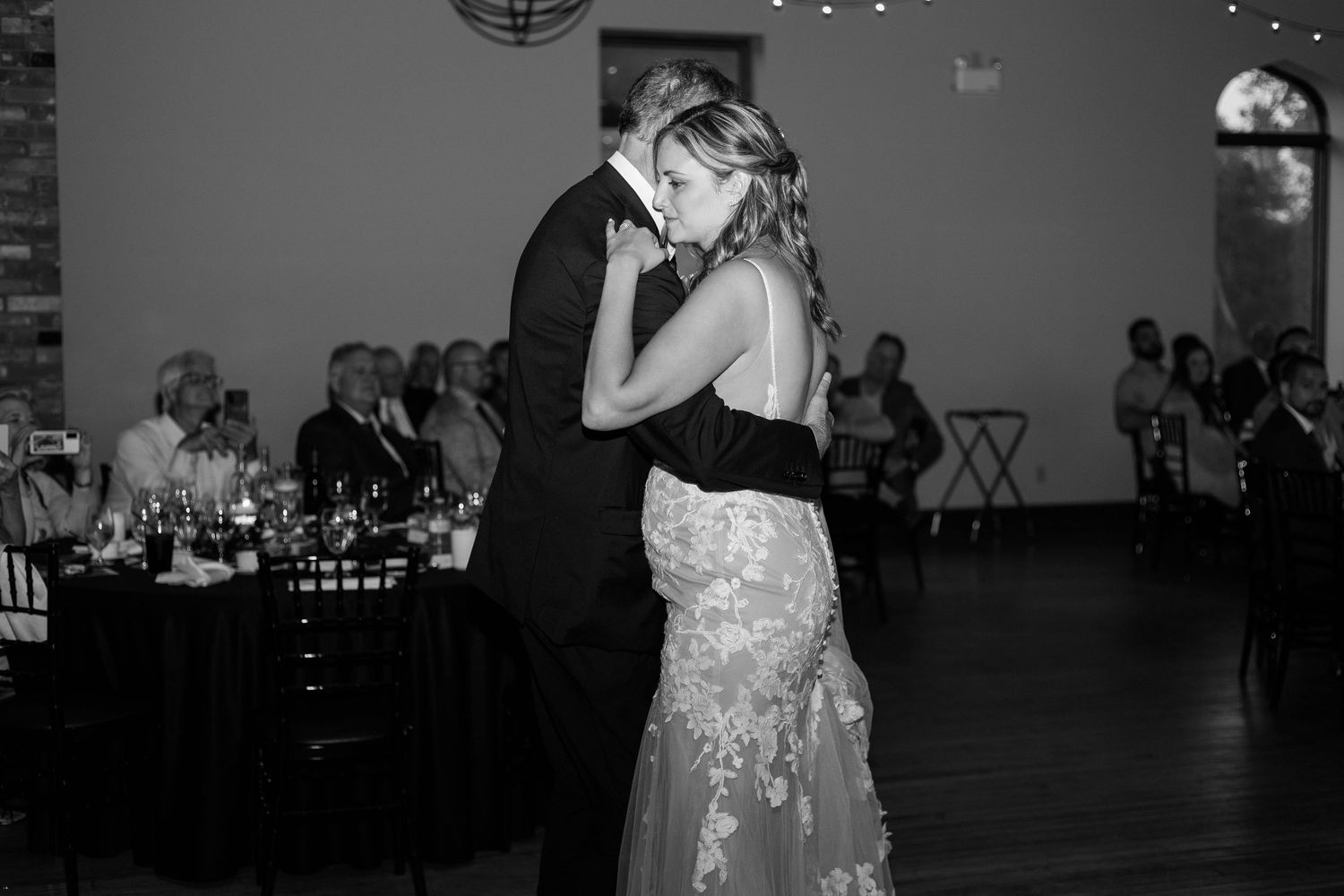 Black and white photo of bride and dad sharing a dance at a wedding reception at Rivers Edge at the Arlington in Paris Ontario.