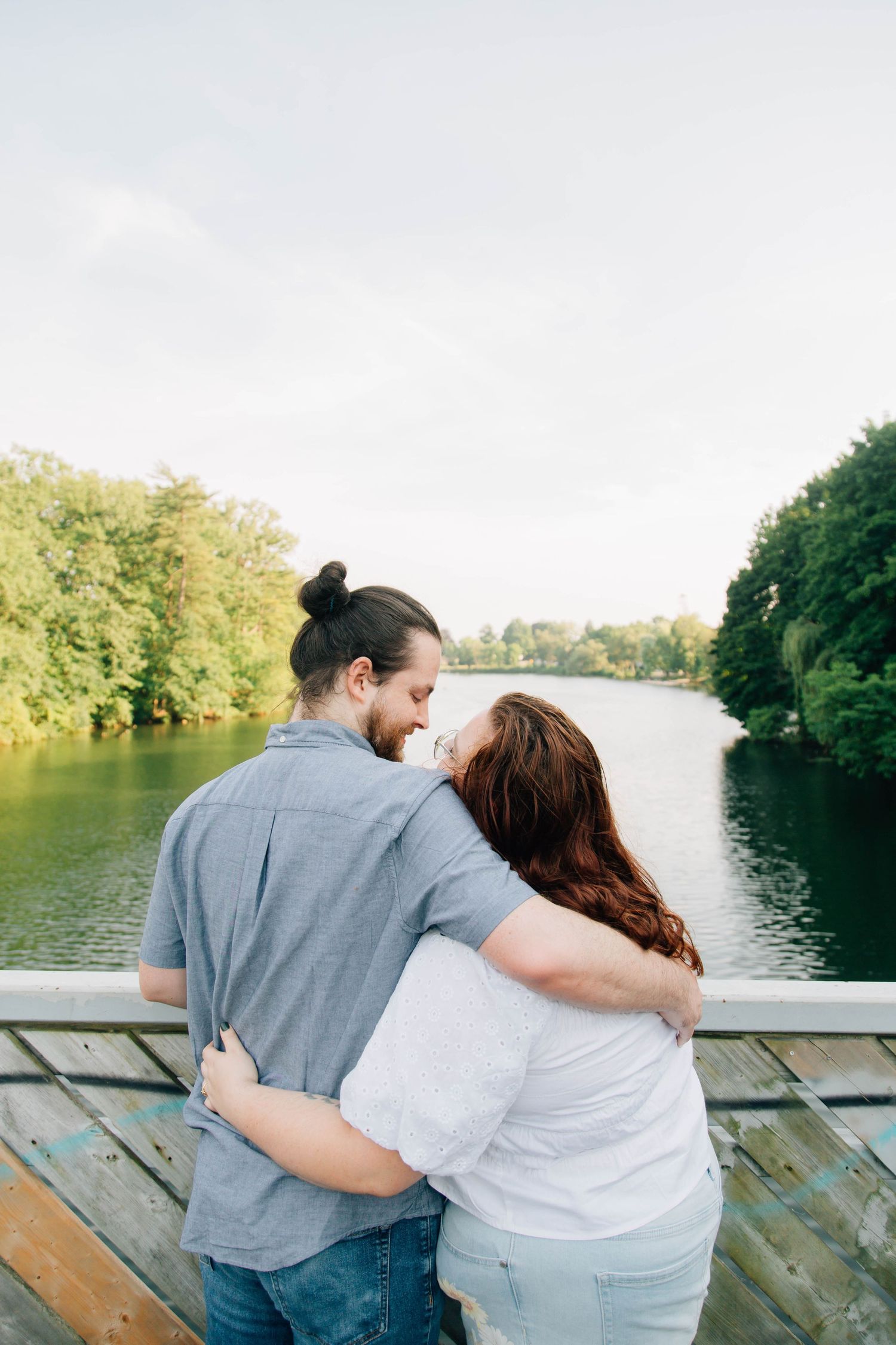 couple cuddling on bridge in tillsonburg