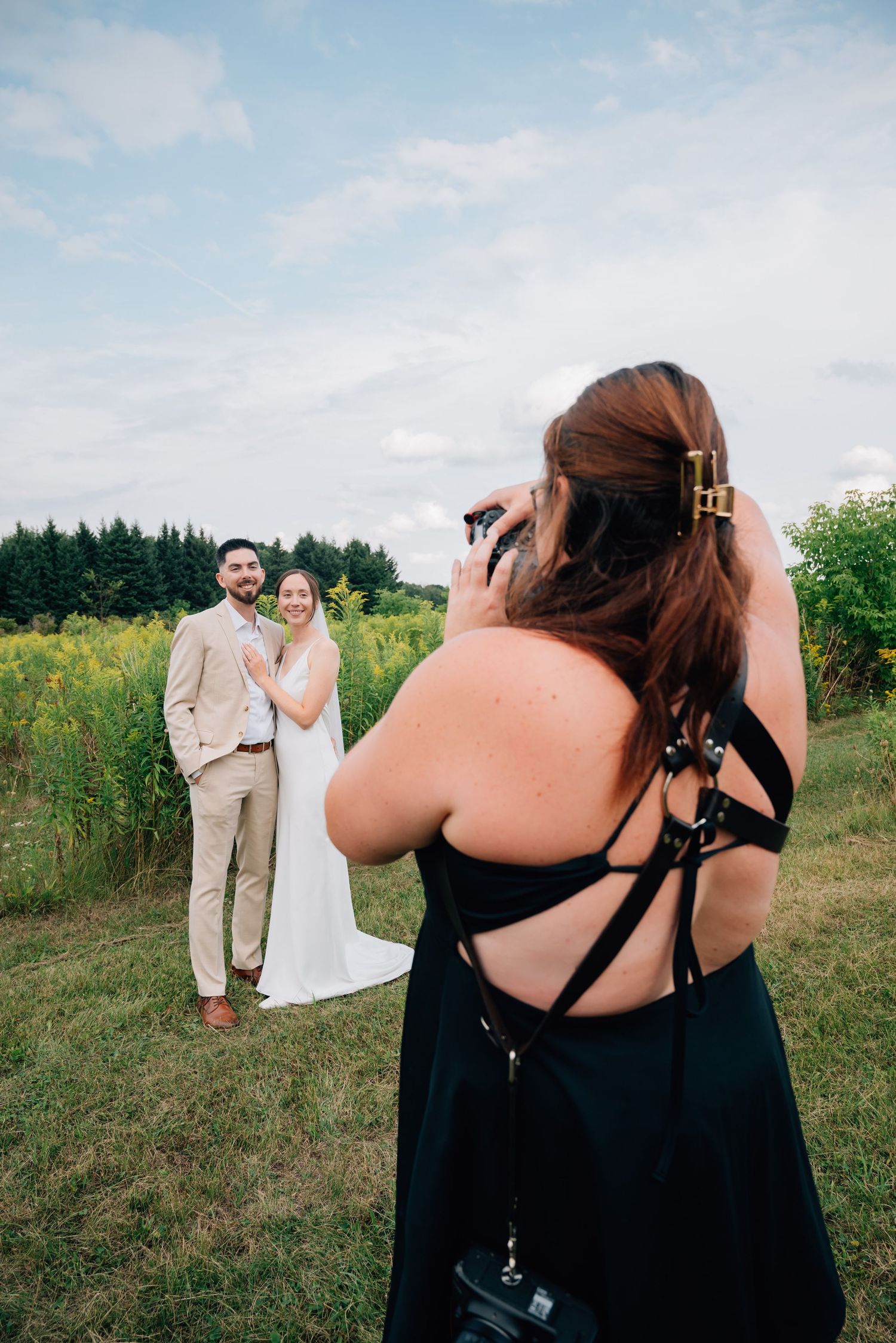 Woodstock Wedding Photographer capturing bride and groom portrait in golden wildflower field outdoors.
