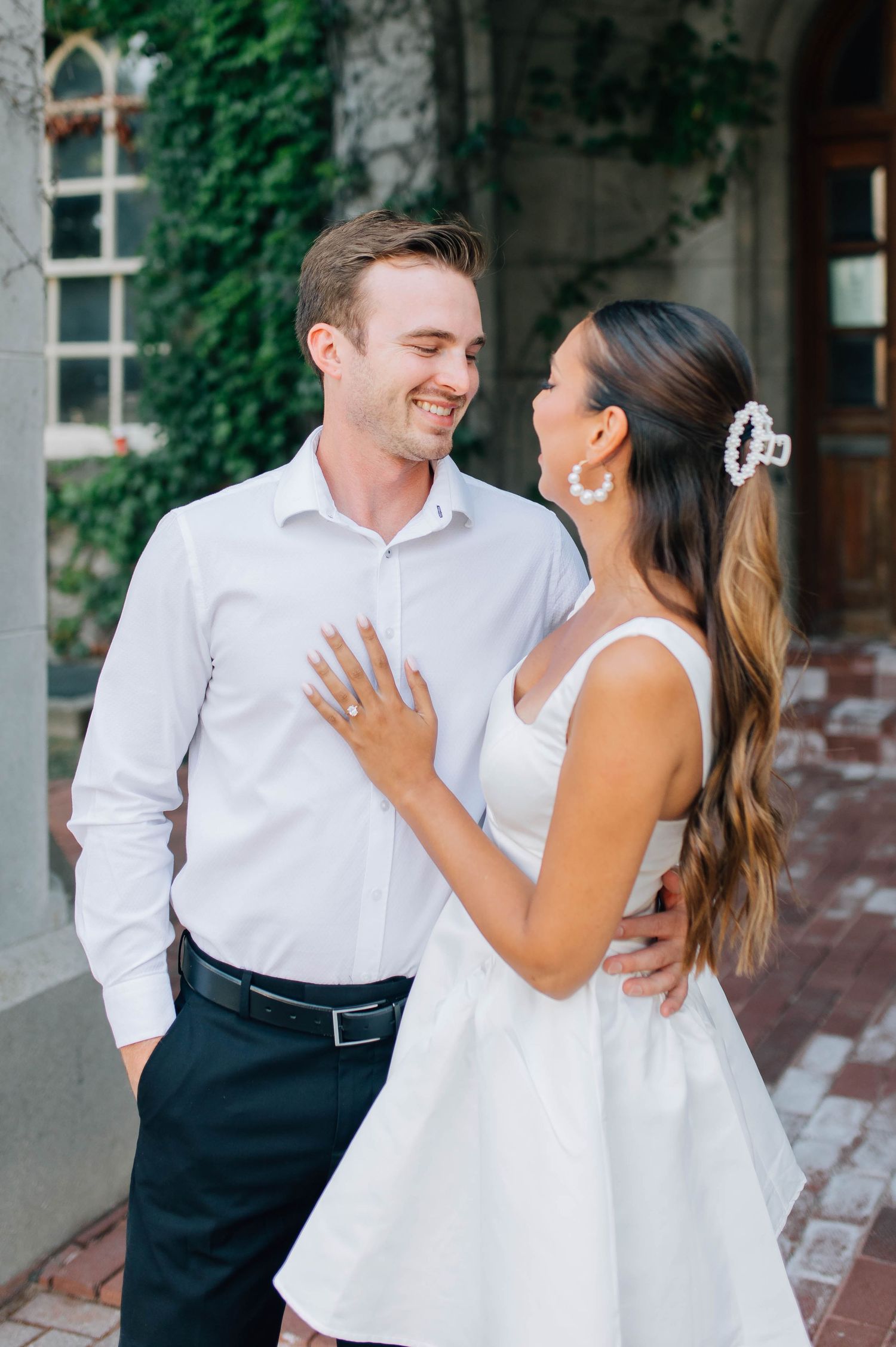 Couple gazing at each other lovingly in front of the Old Courthouse in London Ontario
