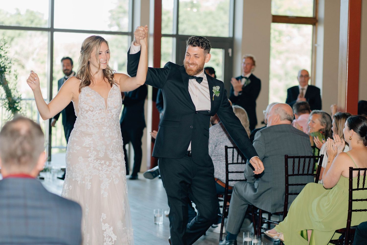 Bride and groom walk down the aisle joyfully after wedding ceremony.