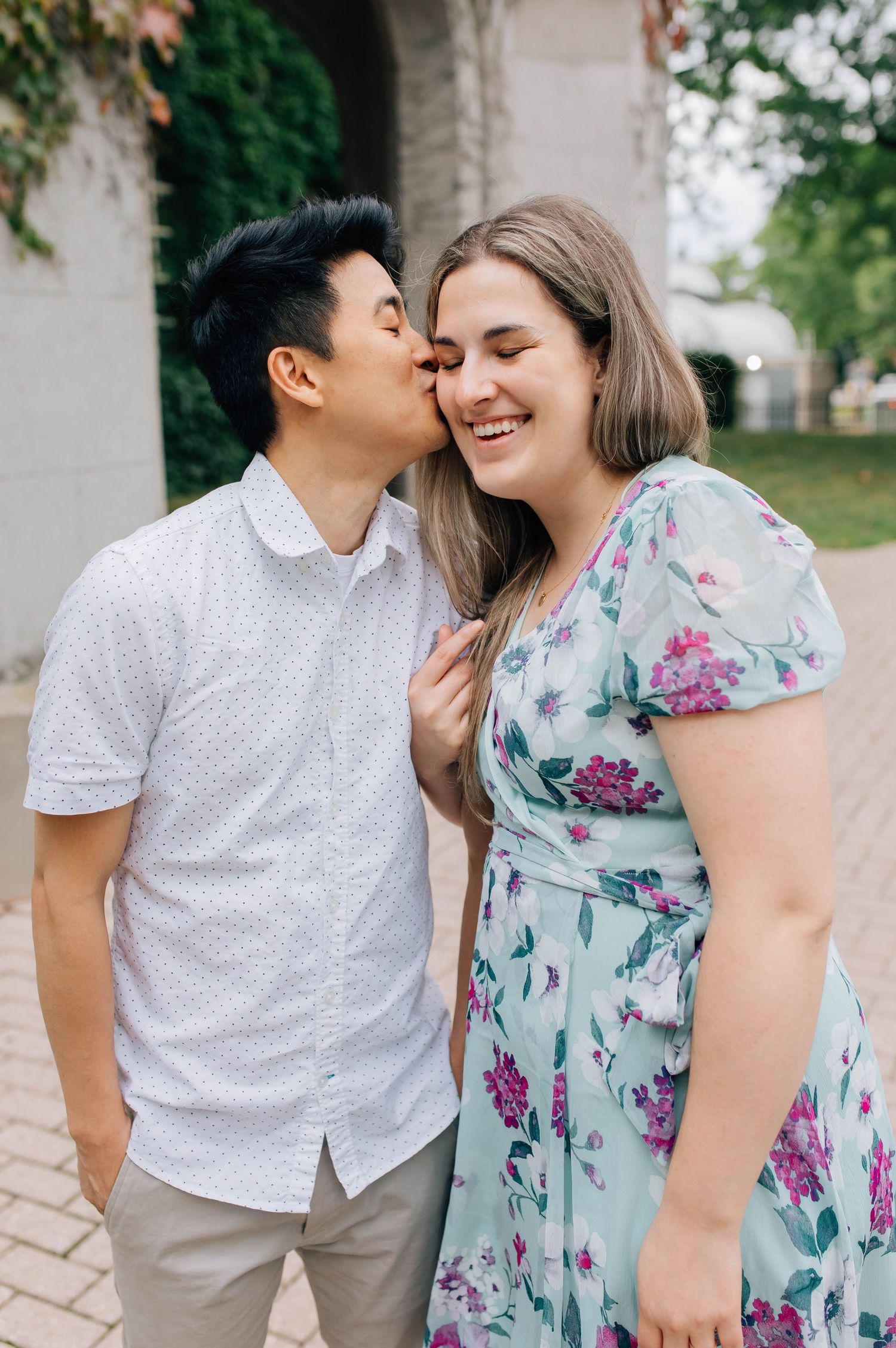 man kissing woman's forehead at engagement session in london ontario