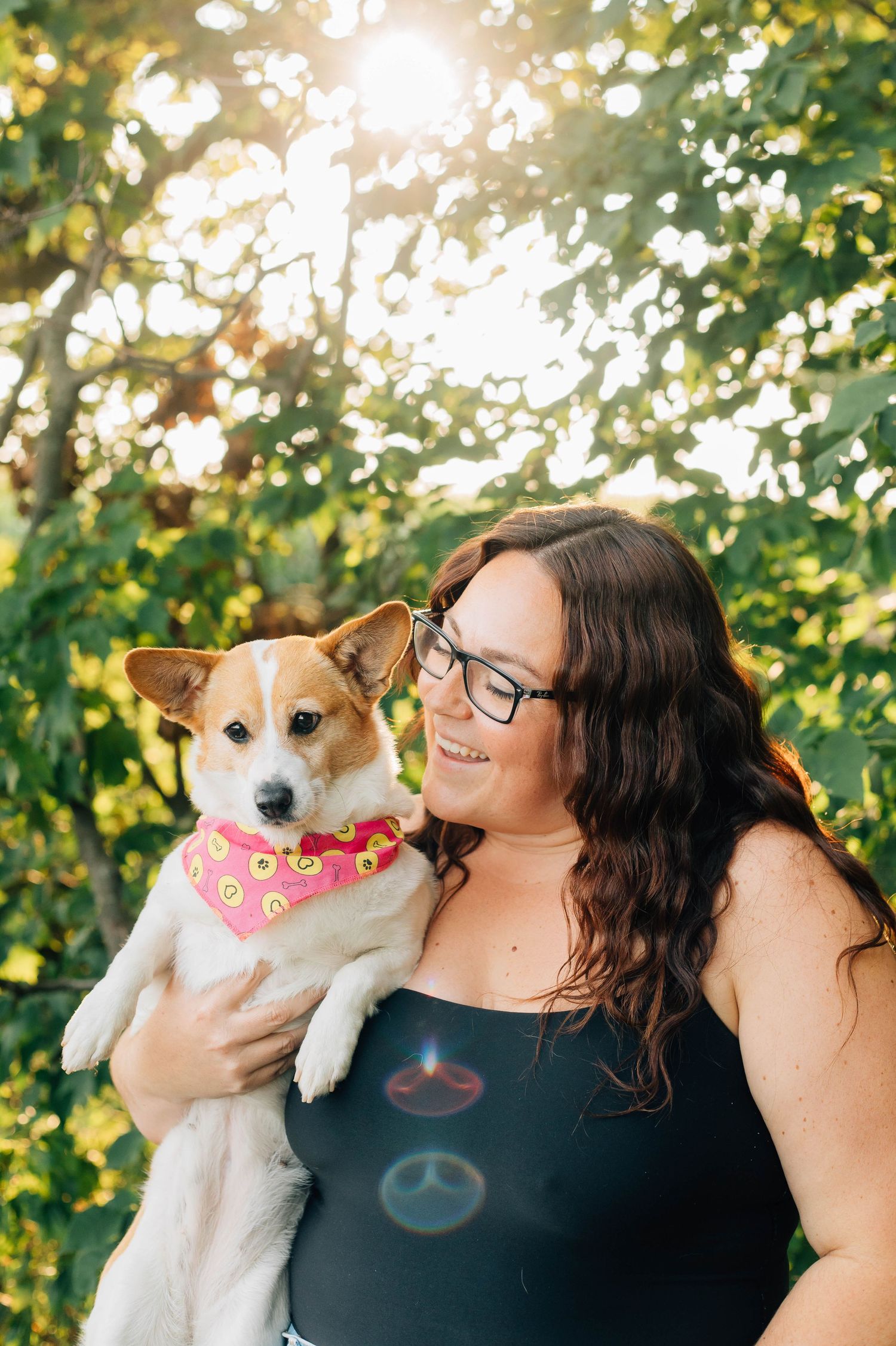 Woodstock wedding photographer smiling at her dog that's wearing a pink bandana.