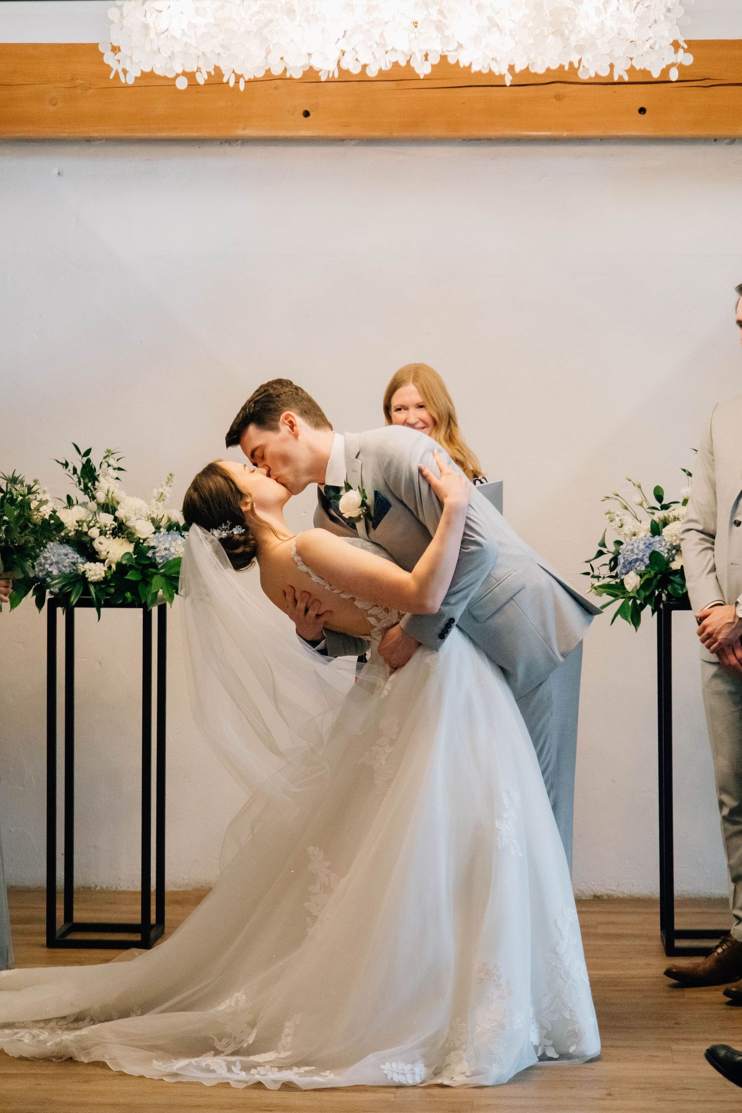 Bride and Groom sharing first kiss during ceremony at the Timber Barn in St. Jacob's Ontario