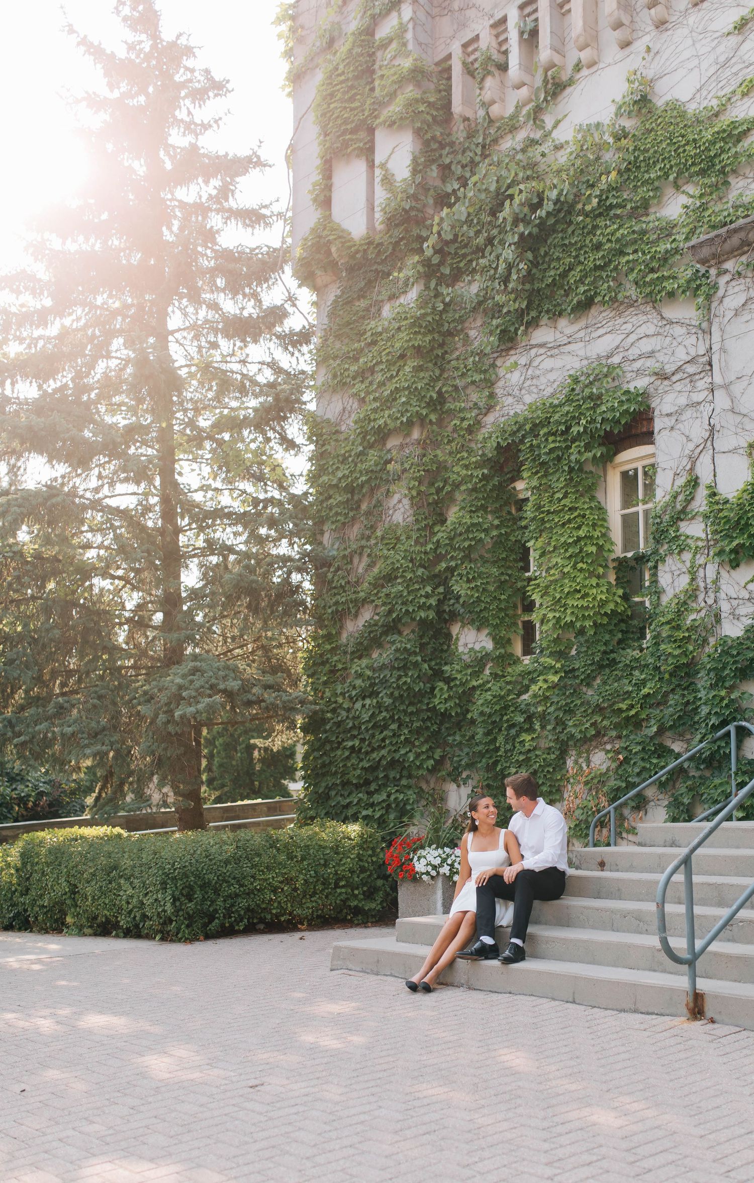 Couple sitting on the steps of the Old Courthouse at sunset in London Ontario