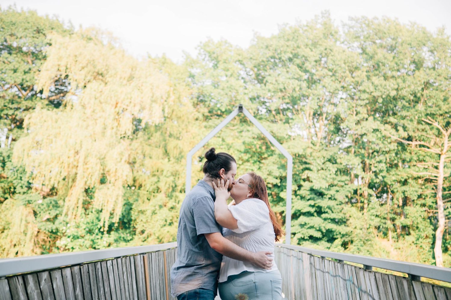 couple kissing on bridge in tillsonburg