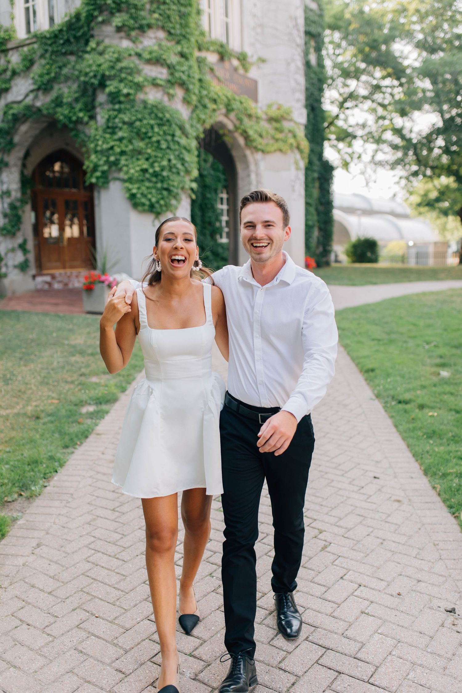 Couple walking in front of the Old Courthouse in London Ontario