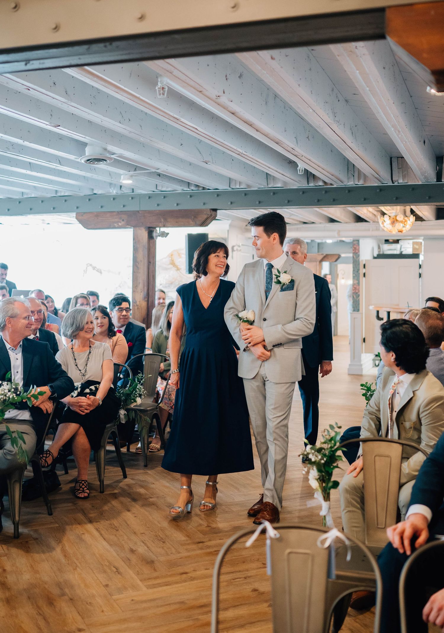 Groom walking down the aisle with his mom at the Timber Barn in St. Jacob's Ontario