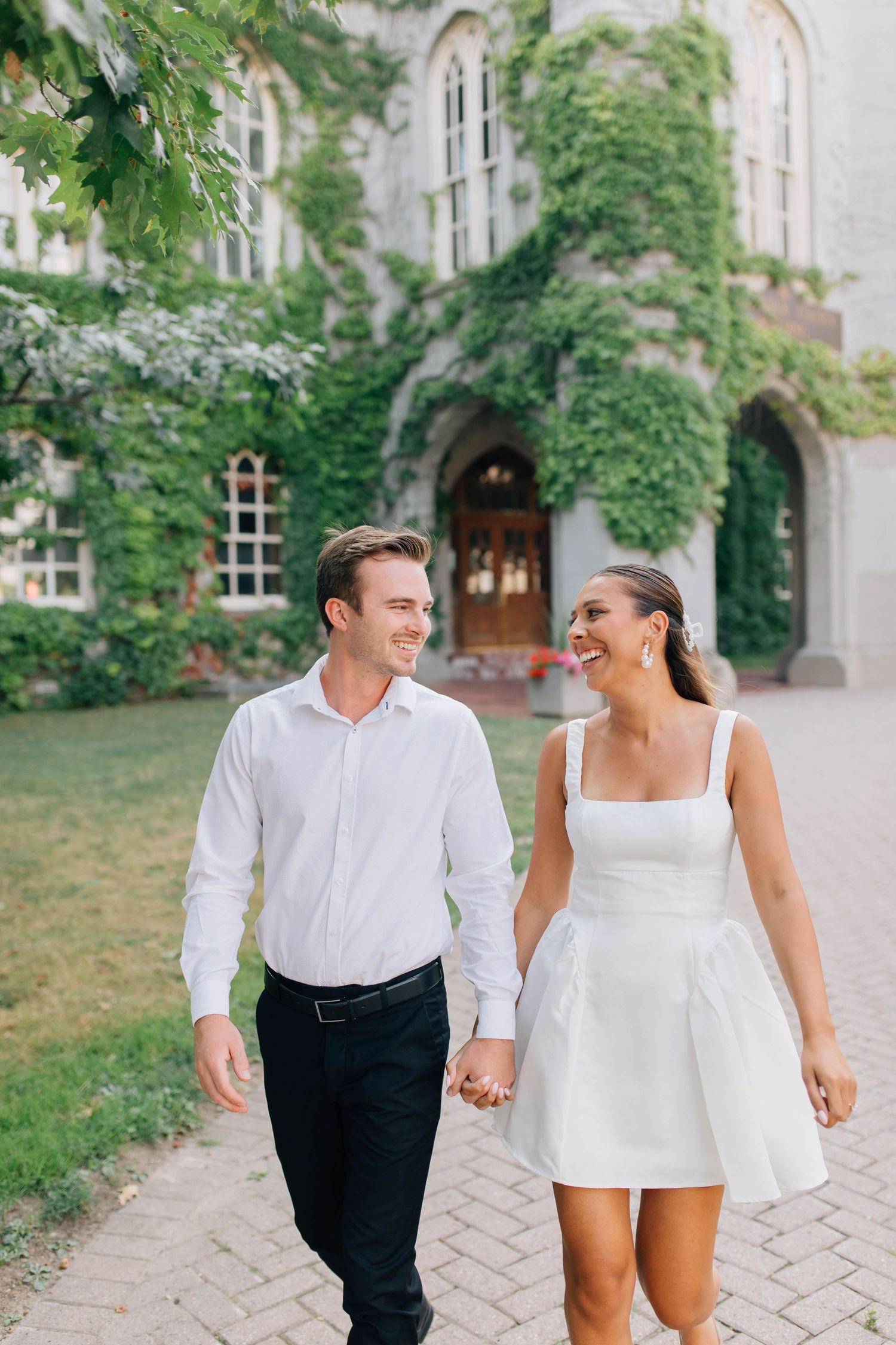 Couple walking in front of the Old Courthouse in London Ontario