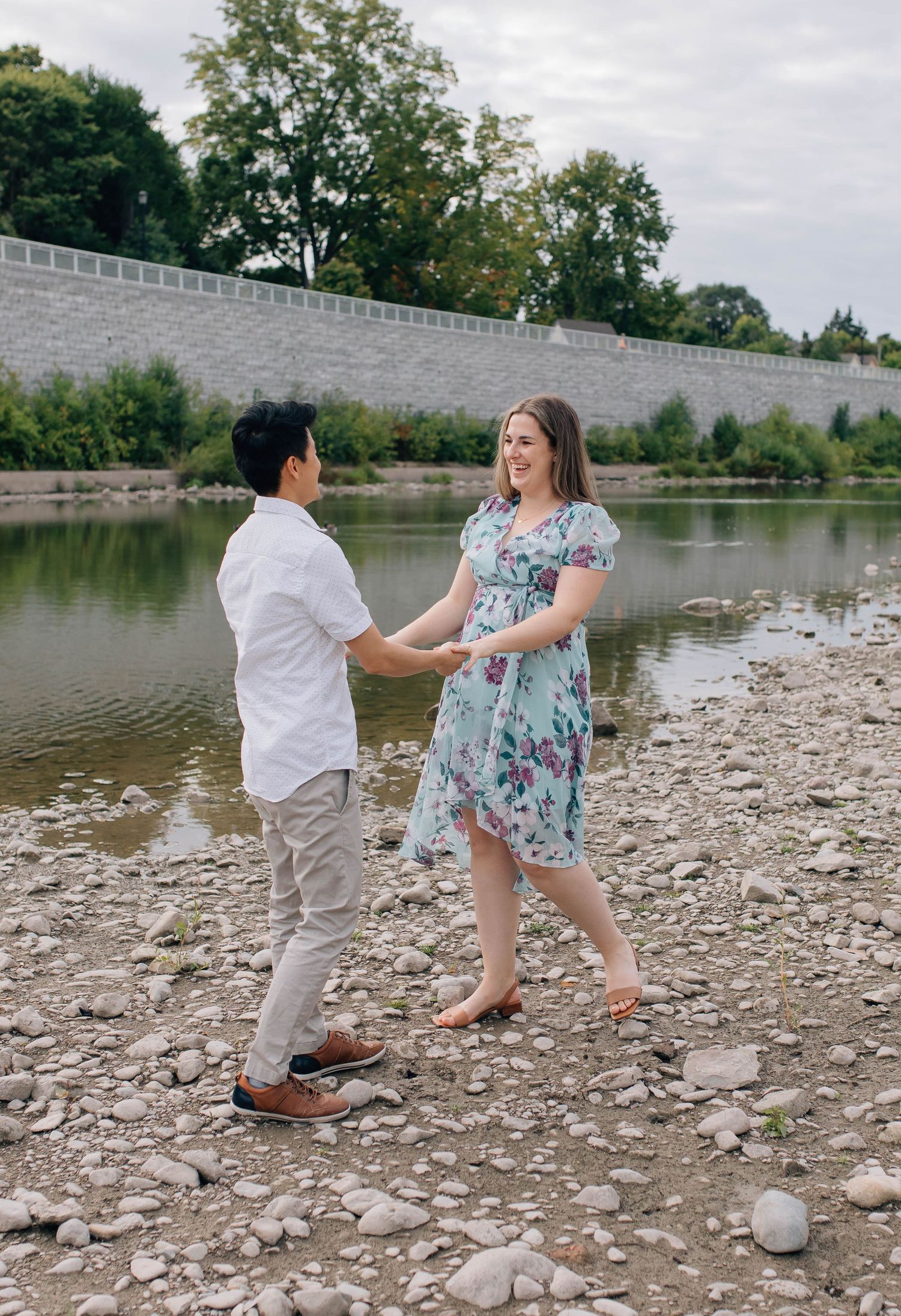 couple walking around harris park during engagement session in london ontario