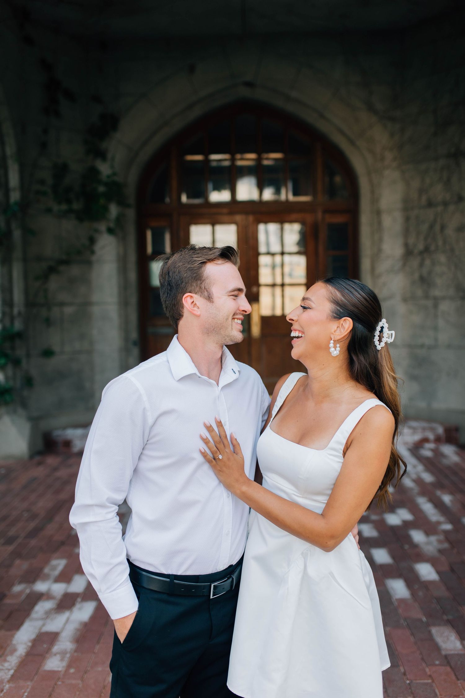 Couple laughing at each other in front of the Old Courthouse in London Ontario