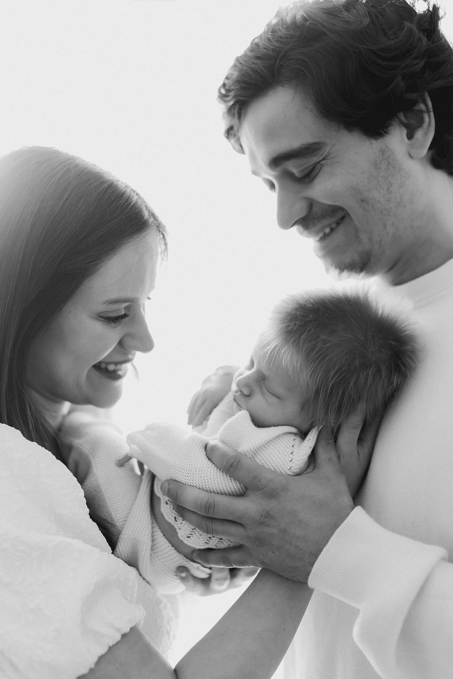 A series of black and white romantic close-up photos showing tender intimate moments between a couple.