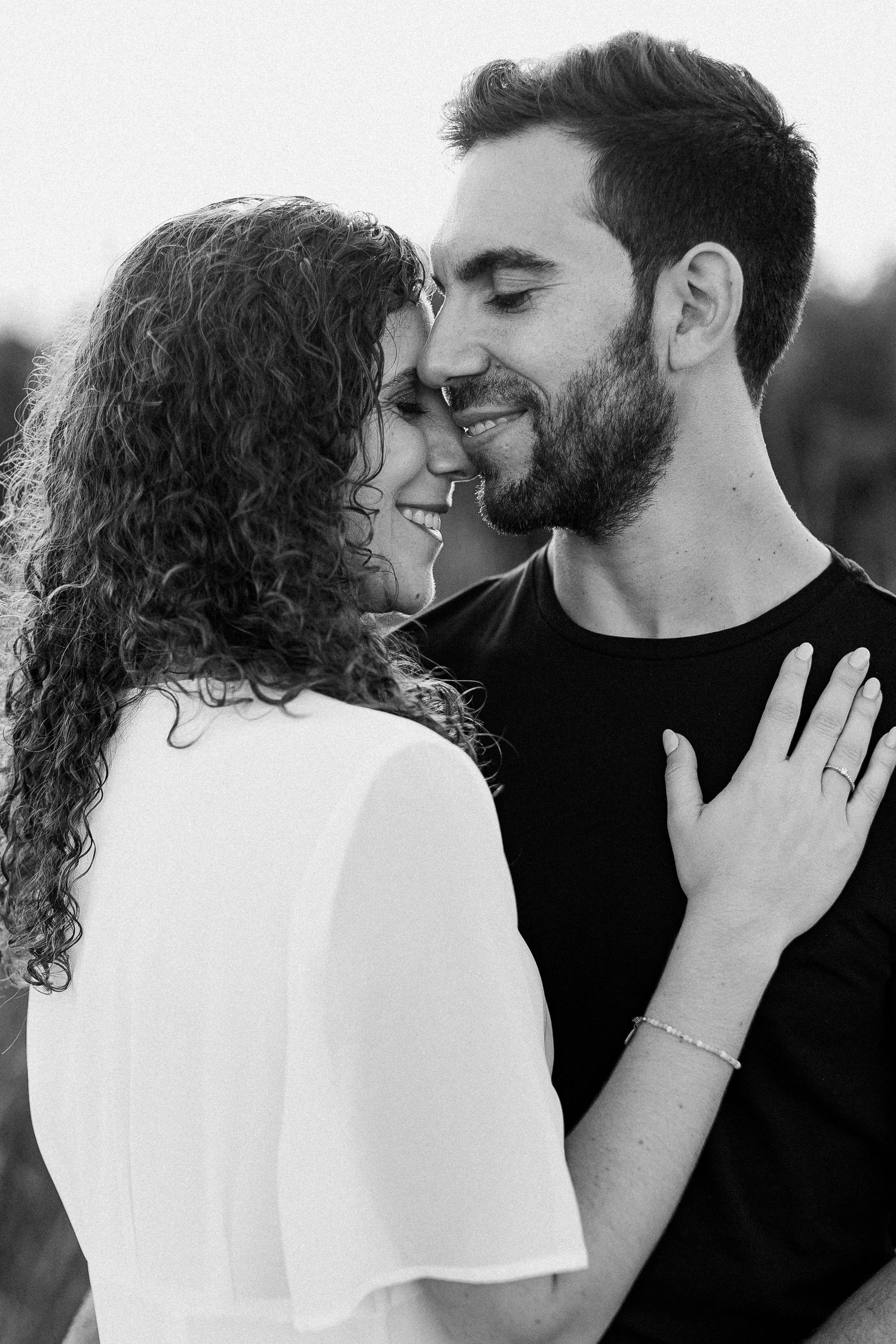 A romantic couple in black and white share tender kisses in a series of intimate photographs.