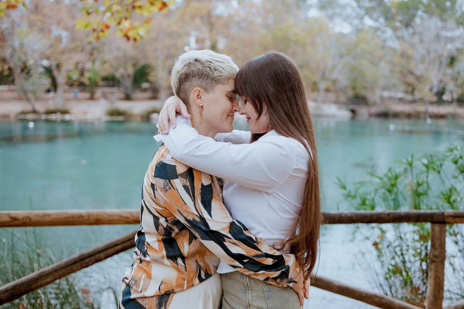 A collection of tender family moments captured outdoors near a turquoise lake with wooden railings in view.