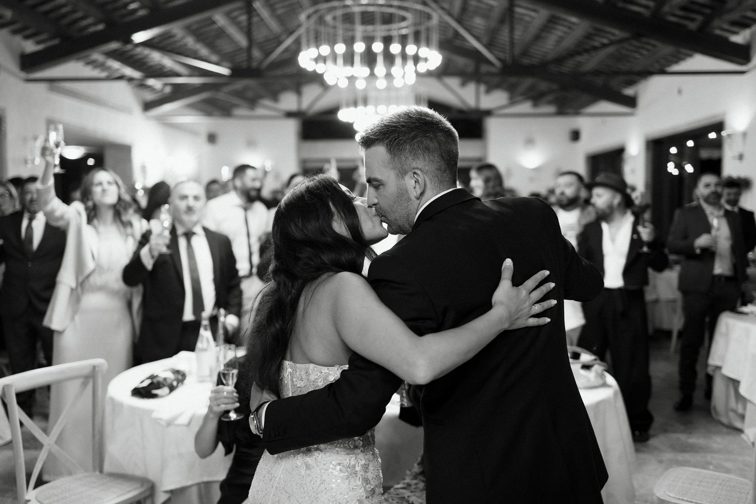 Black and white photo of bride and groom sharing their first dance at reception.