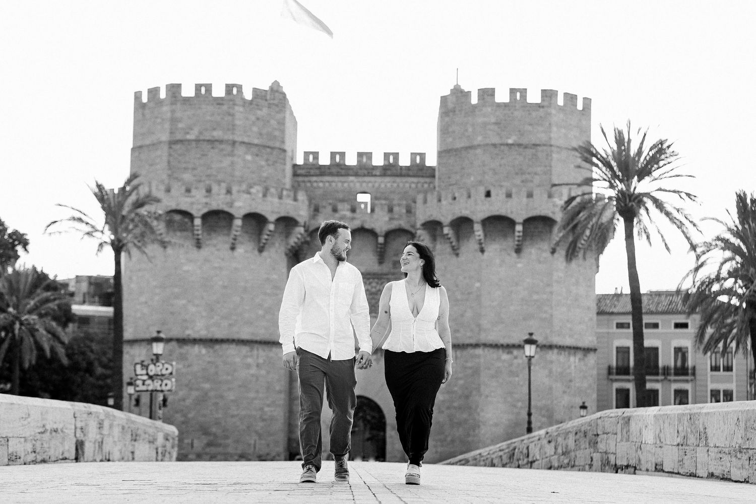 A series of photos showing people walking along ancient stone fortress walls with crenellated battlements and towers.