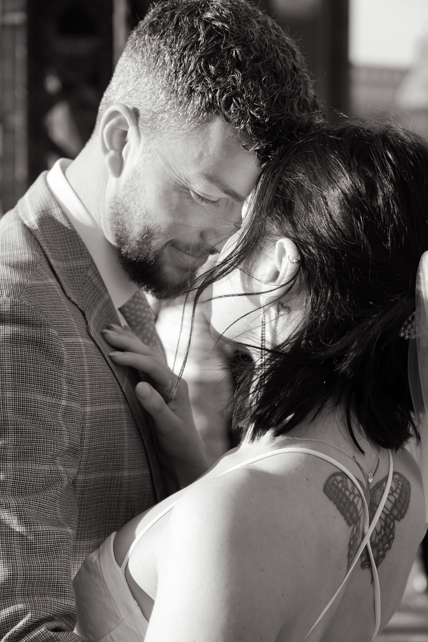 Intimate black and white close-up of couple sharing tender moment.