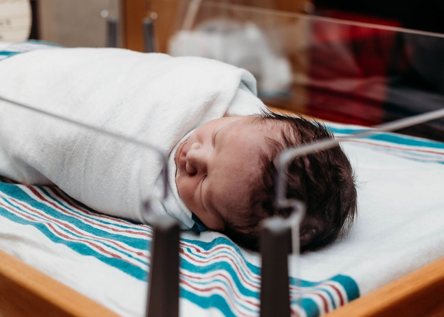 Baby laying in hospital bassinet