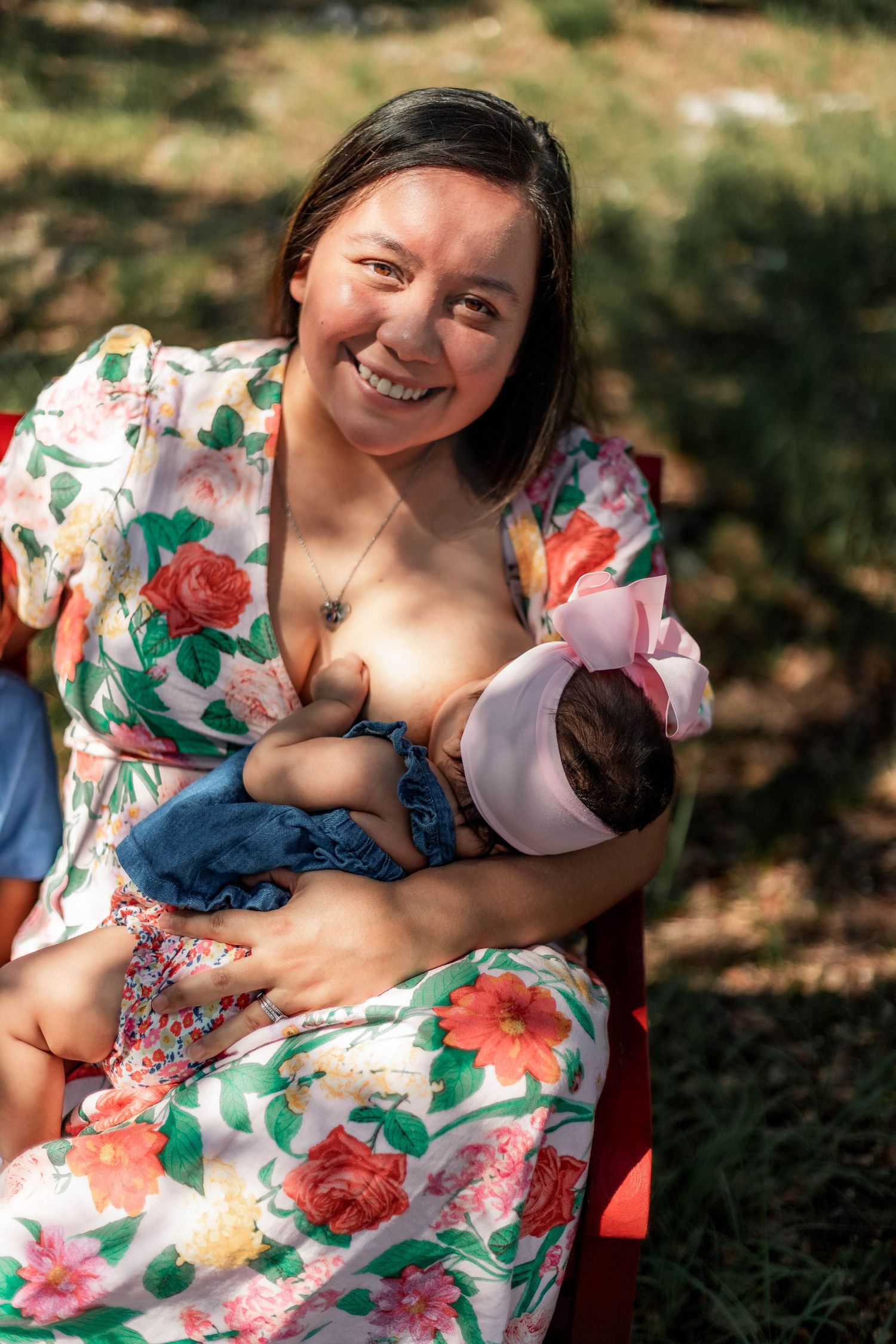 mother nurses baby on bench