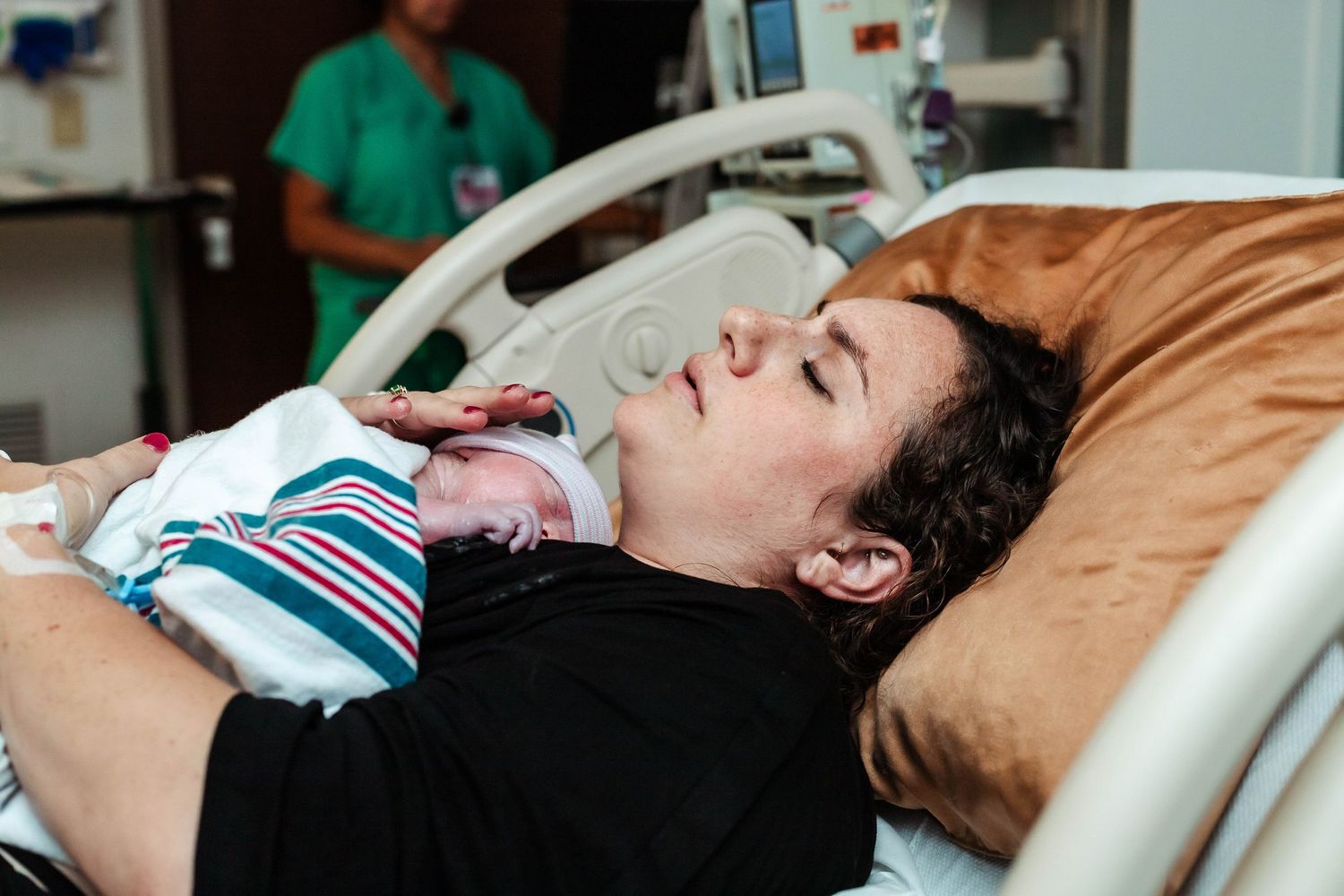 mother holds baby after delivery