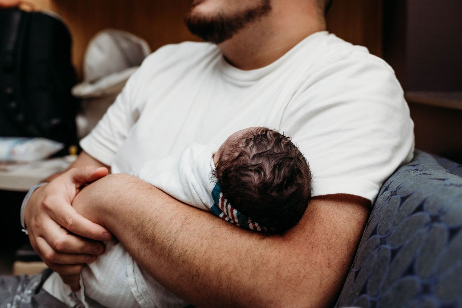 Top of baby's head, baby being held by father
