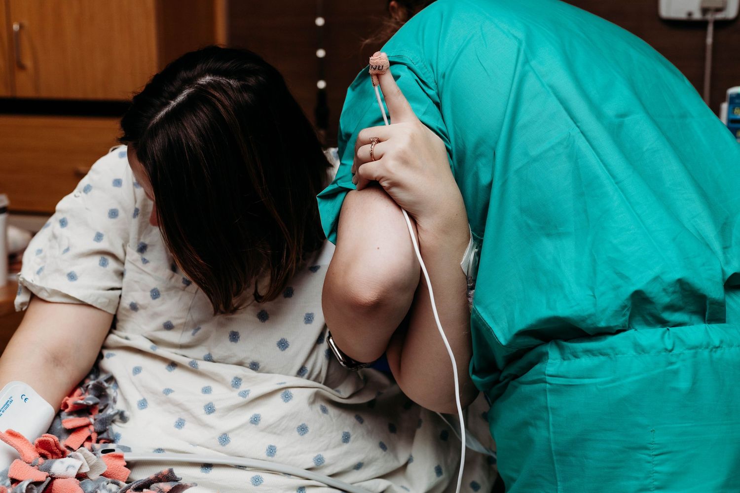 Nurse helps hold up mother