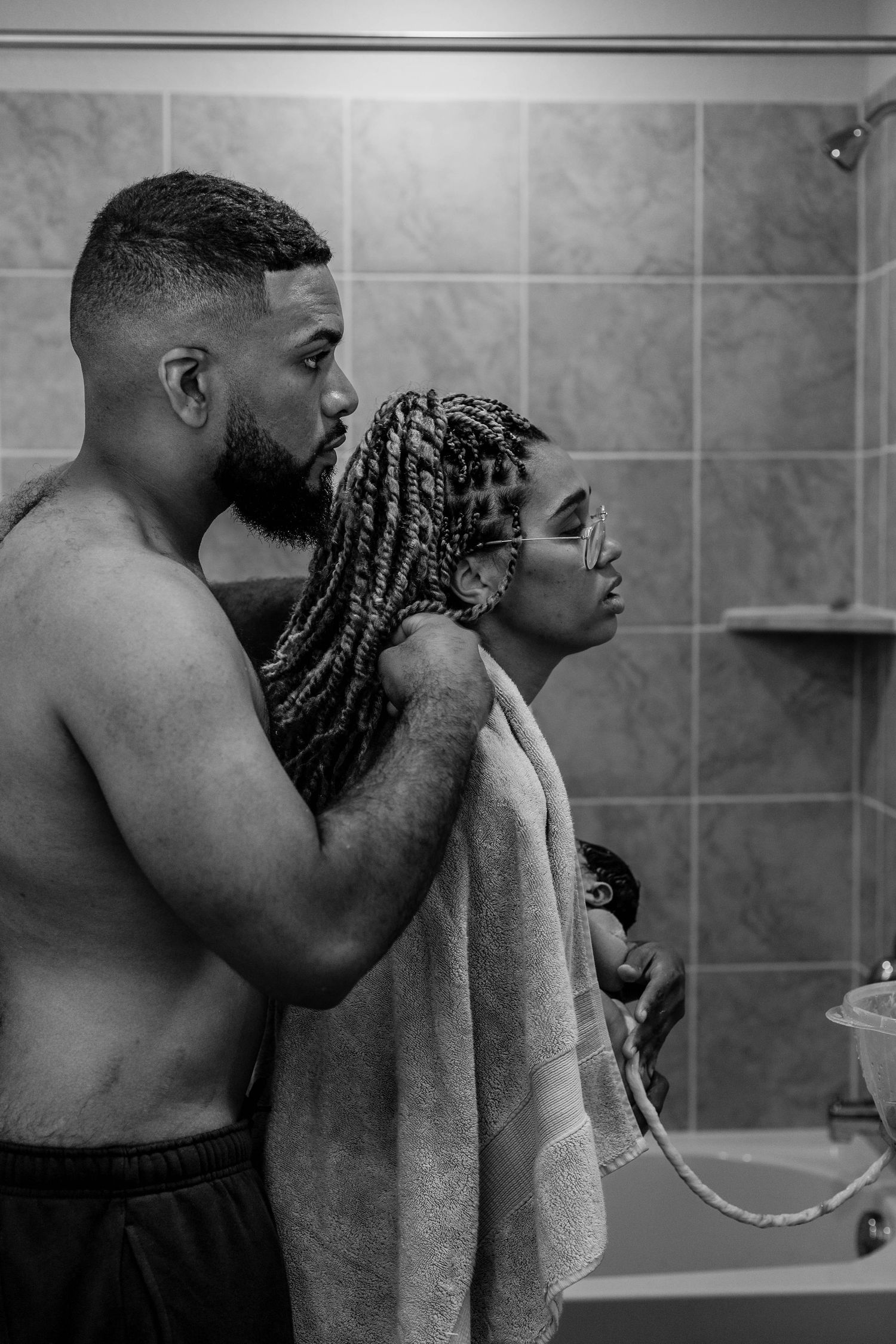 Husband helps with get covered with towel after homebirth