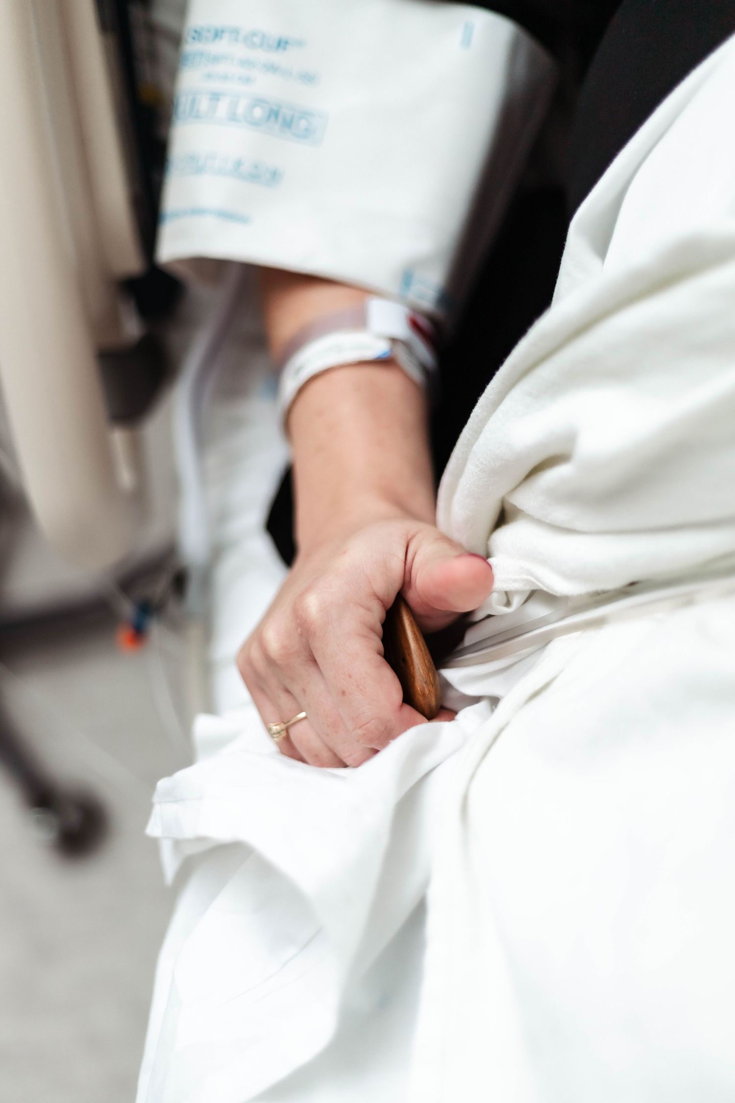 Laboring mother squeezes her birthing comb for pressure point pain relief