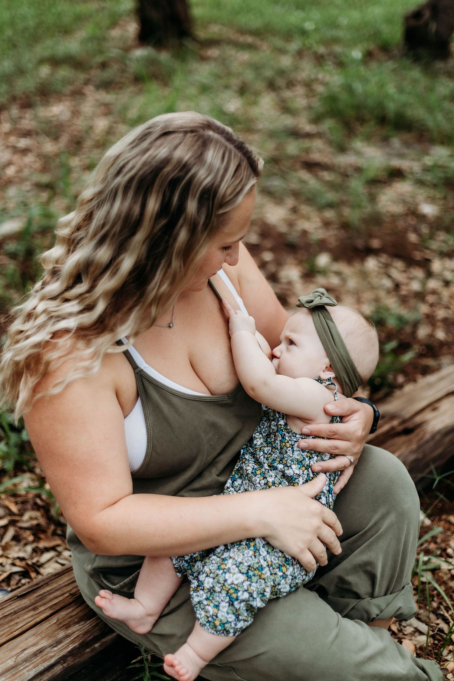 mother nurses baby outside
