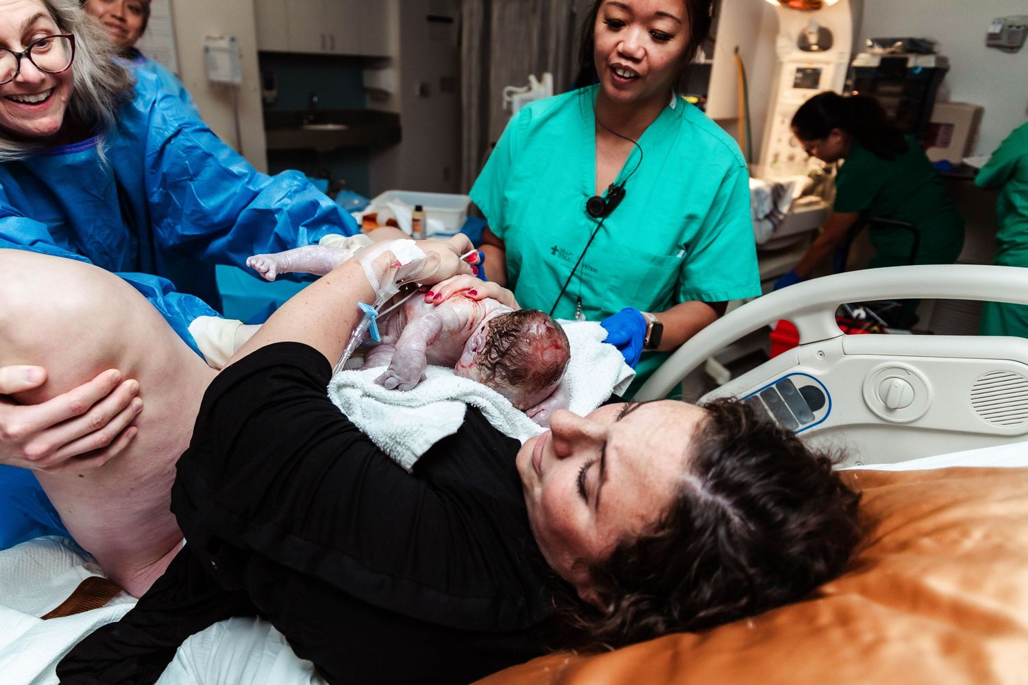 OB hands mother her baby